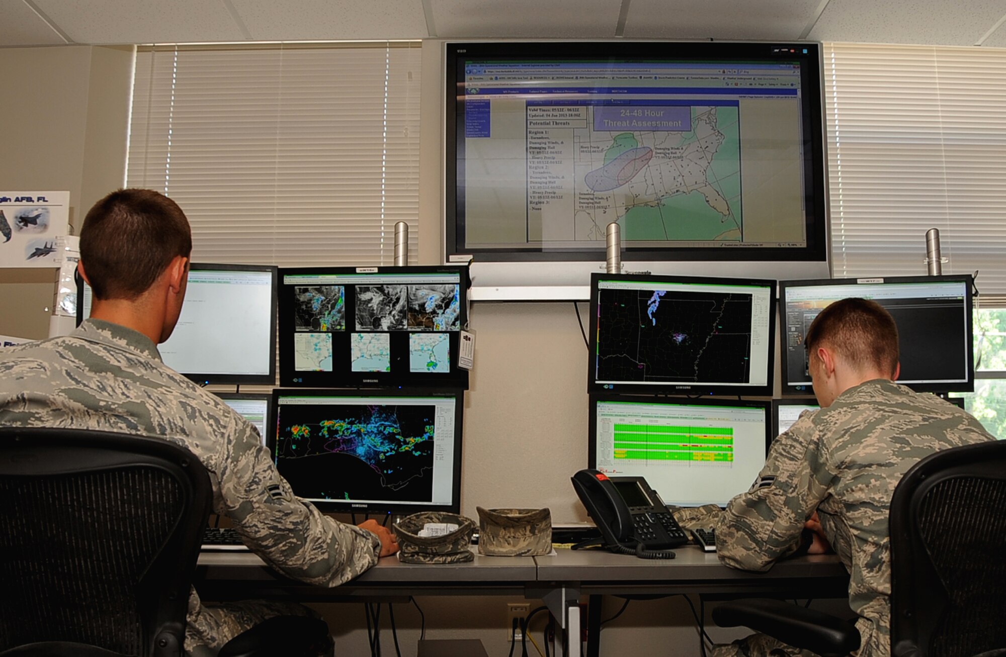 Airman 1st Class Ryan Bielli, left, and Airman 1st Class Anders Aarness, 26th Operational Weather Squadron weather forecasters, monitor weather patterns for Region 2 on Barksdale Air Force Base, La., June 4, 2013.  The 26th OWS monitors 13 states to produce products for mission planning and base residents disaster preparedness planning . (U.S. Air Force photo/Staff Sgt. Jason McCasland)