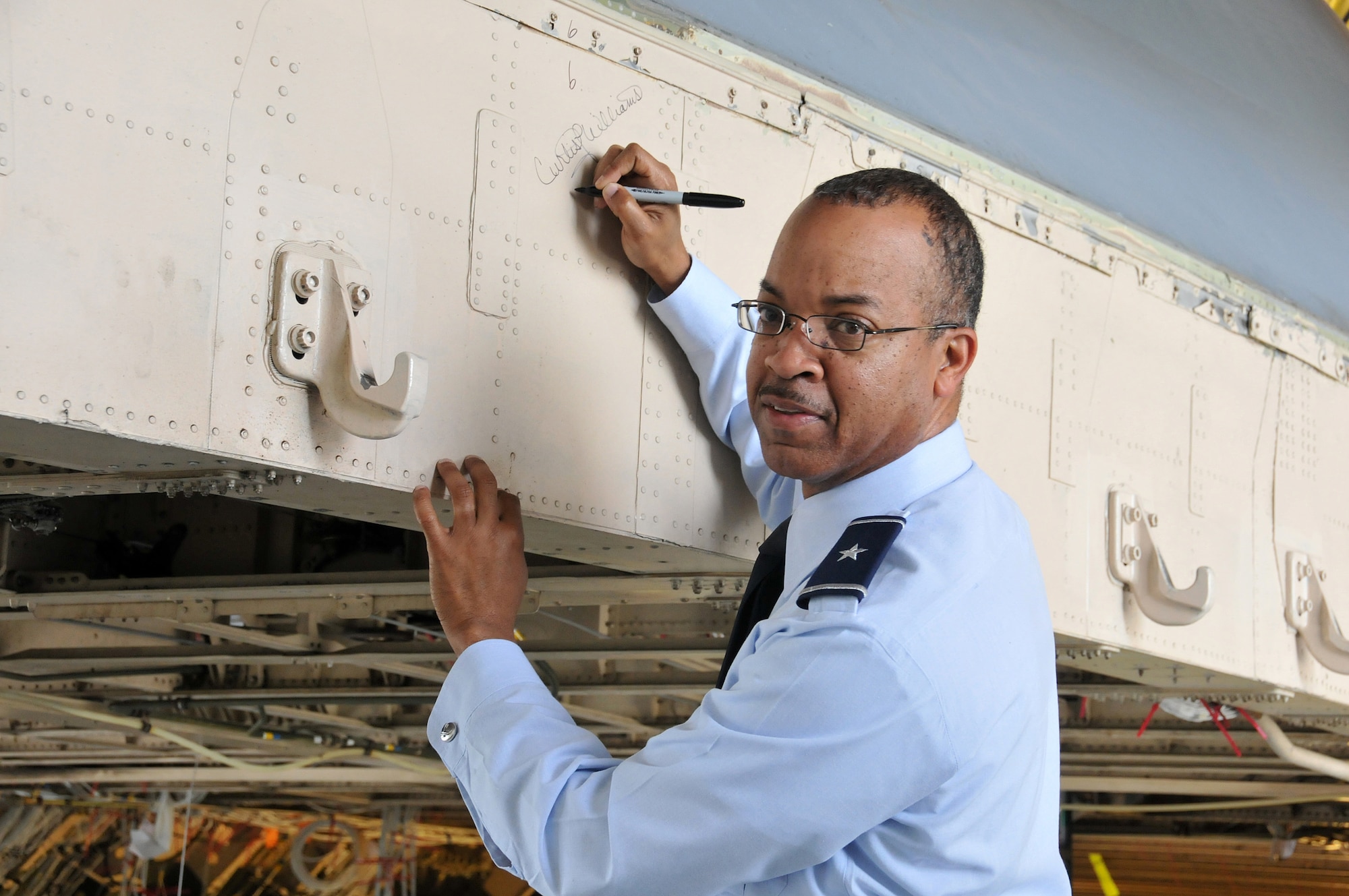 Brig. Gen. Curtis L. Williams, 22nd Air Force vice commander, signed the hull of a C-5 Galaxy that was being re-tooled. Williams visited Lockheed Martin’s Marietta plant on June 3 as an orientation and overview to his duties as a senior 22nd AF official. (U.S. Air Force photo/Senior Airman Elizabeth Van Patten)