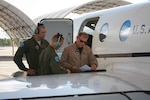 Second Lts. Jeremy Mooneyand Chad James, and Mr. Kevin Salonman, all of the 451st Flying Training Squadron, go over mission information prior to the first flight of the modified T-1 Jayhawk aircraft June 4, 2013 at Naval Air Station Pensacola, Fla. The aircraft has been modified for electronic warfare training, marking the first time in Air Force history that an undergraduate aviation program has formally incorporated the fundamentals of electronic warfare in flight into their syllabus.  (U.S. Air Force photo by Airman 1st Class Kailyn Cabrera)