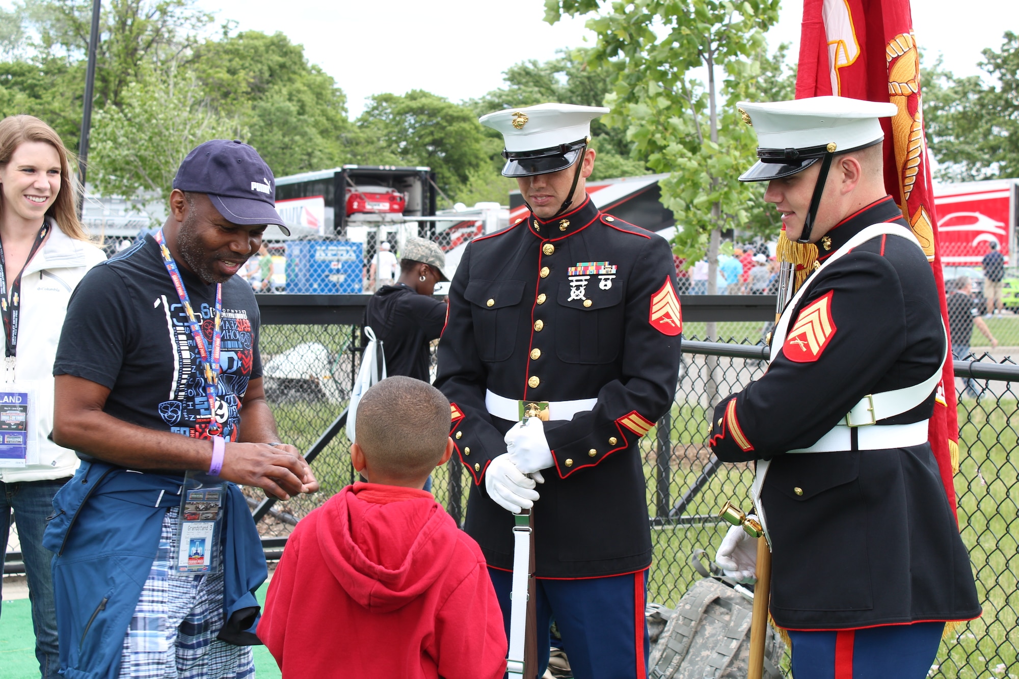 130601-Z-NV943-120: Marines from Selfridge Air National Guard Base, Mich., talk to a young fan before presenting the colors during pre-race festivities on June 2, 2013, during the 2013 Chevrolet Detroit Belle Isle Grand Prix. More than 50 military members from the various branches and units at Selfridge took part in five volunteer events over the race weekend. Grand Prix officials invited the military members to participate in the events to show their appreciation for their service. (U.S. Air National Guard photo by Angela Pope/Released)