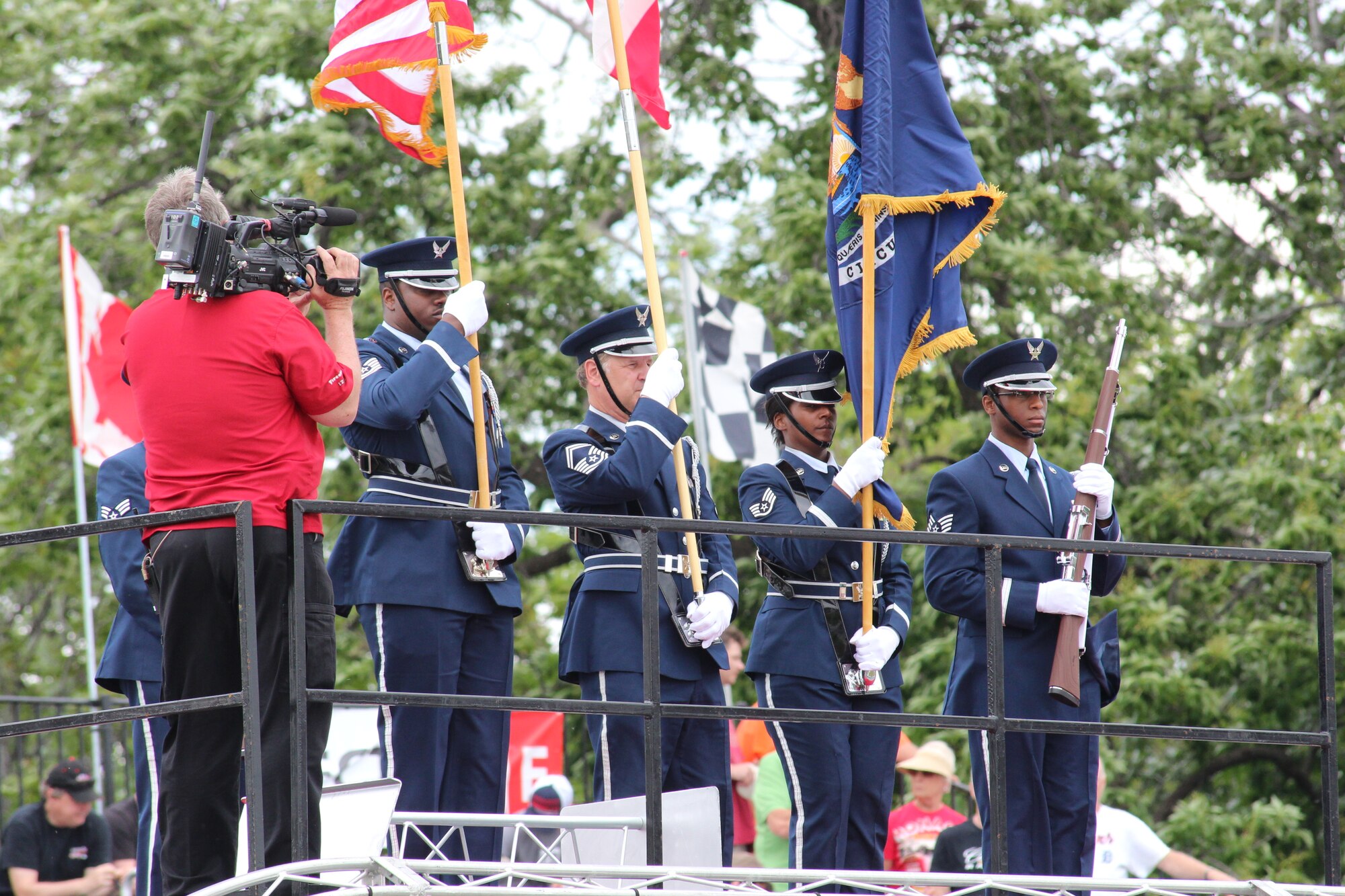 130601-Z-NV943-085: Members of the Selfridge Air National Guard Base, Mich., Honor Guard stand ready to present the colors prior to the start of a race on June 1, 2013, during the 2013 Chevrolet Detroit Belle Isle Grand Prix. More than 50 military members from the various branches and units at Selfridge took part in five volunteer events over the race weekend. Grand Prix officials invited the military members to participate in the events to show their appreciation for their service. (U.S. Air National Guard photo by Angela Pope/Released)