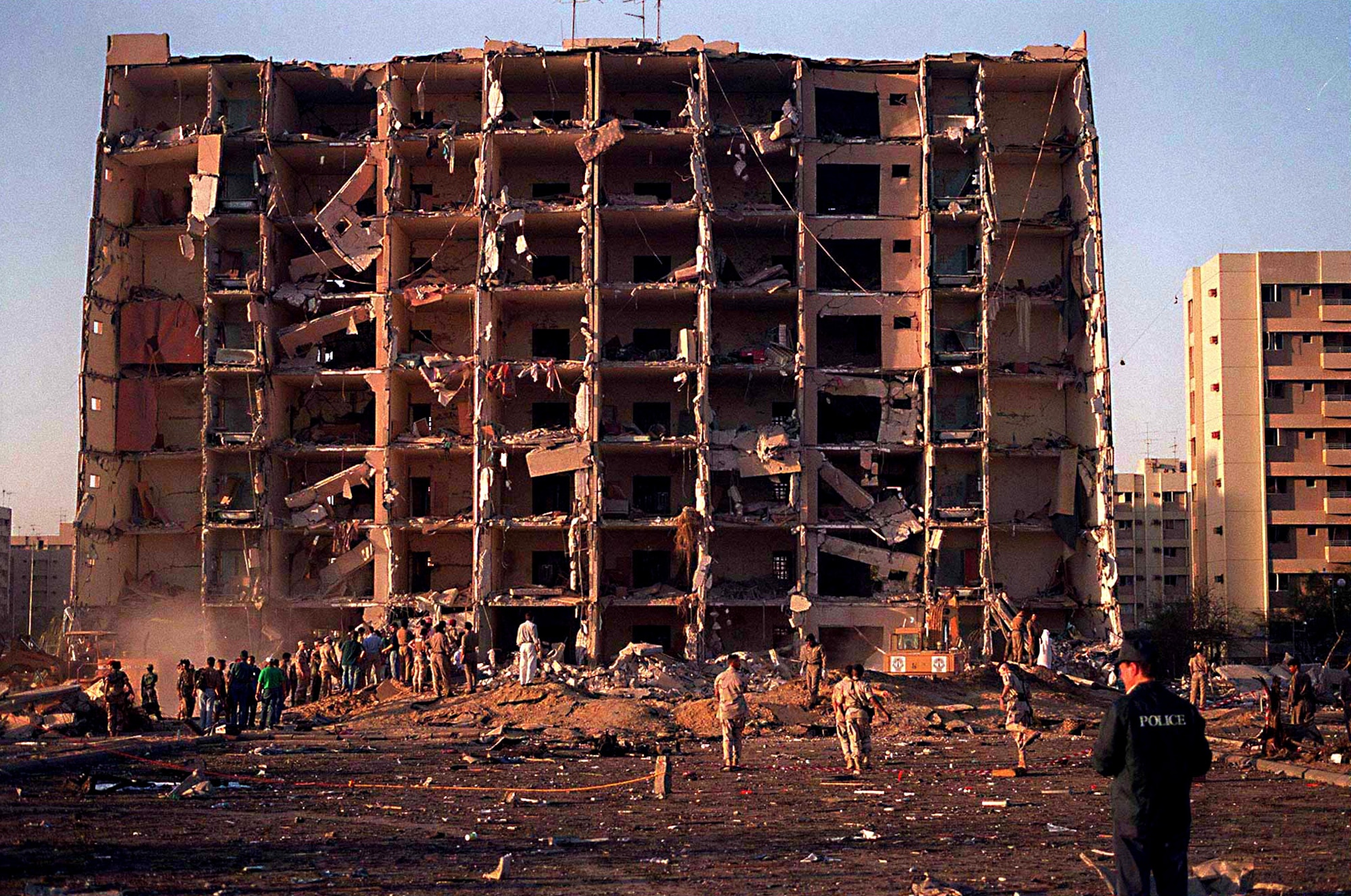 U.S. and Saudi military personnel survey the damage to Khobar Towers caused by the explosion of a fuel truck outside the northern fence of the facility on King Abdul Aziz Air Base near Dhahran, Saudi Arabia, at 2:55 p.m. EDT, Tuesday, June 25, 1996. Several buildings were damaged and there were numerous U.S. casualties. The latest information from Dhahran indicates that 19 people are dead and 64 people are hospitalized. Additionally, over 200 have been treated for injuries and released. The facility houses U.S. service members and serves as the headquarters for the U.S. Air Force's 4404th Wing (Provisional), Southwest Asia. (DoD photo/Released)