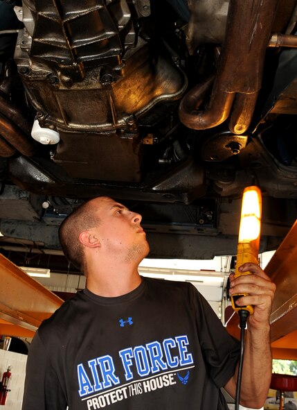 Airman 1st Class Alec Steinert, 2nd Aircraft Maintenance Squadron hydraulics, inspects the underside of his car before removing a bad starter at the Auto Hobby Shop on Barksdale Air Force Base, La., June 3, 2013.  The Auto Hobby Shop is open every Monday, Thursday, Friday and Saturday at 8 a.m. to 6 p.m. and Tuesday and Wednesday at 8 a.m. to 7 p.m., for do-it-yourselfers to work on their cars, motorcycles, ATV's and more.  (U.S. Air Force photo/Staff Sgt. Jason McCasland)