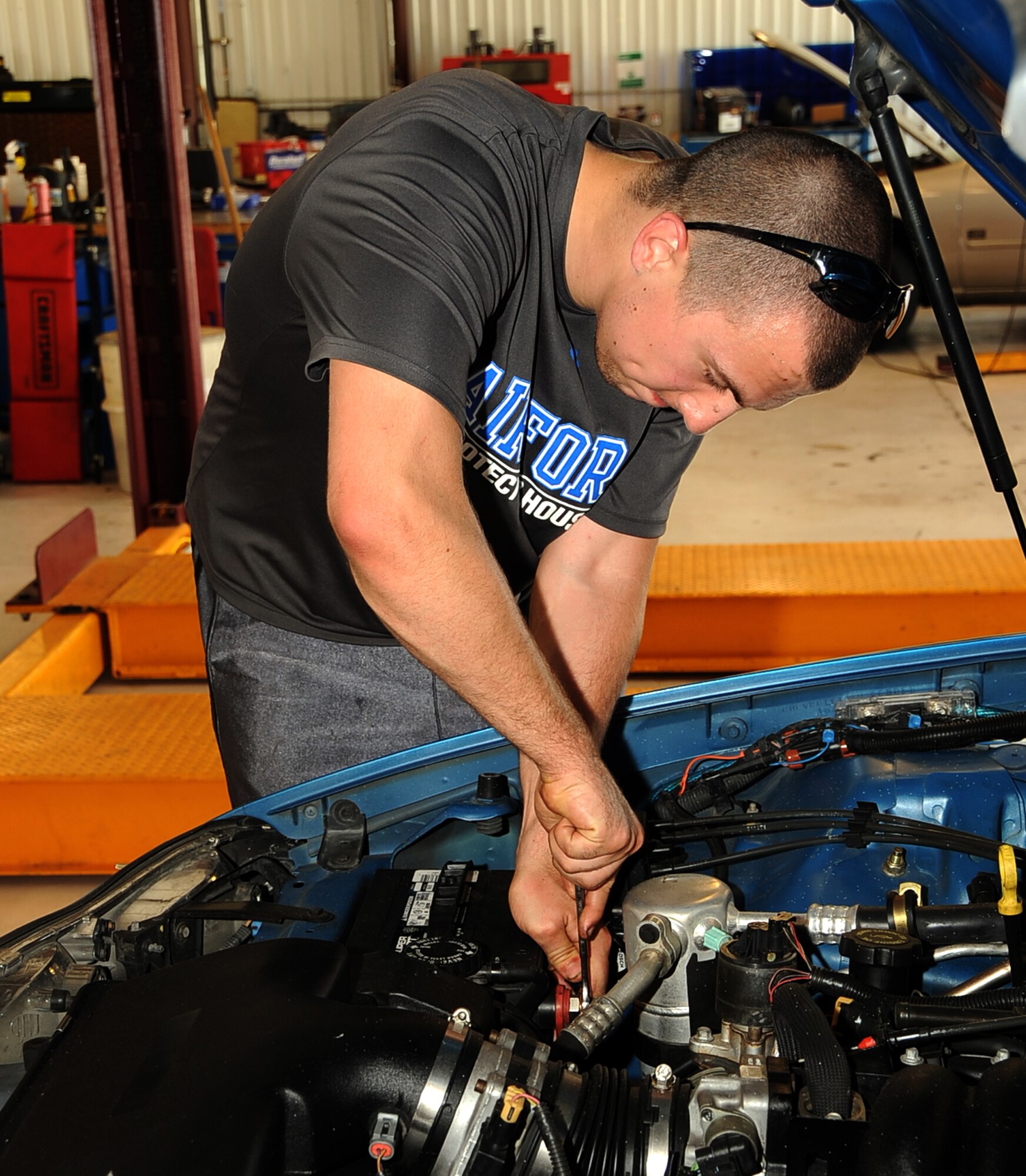 Airman 1st Class Alec Steinert, 2nd Aircraft Maintenance Squadron hydraulics, disconnects a battery cable from his car at the Auto Hobby Shop on Barksdale Air Force Base, La., June 3, 2013. The Auto Hobby Shop provides a do-it-yourself location for car enthusiasts to care for their vehicles and avoid possible costly repairs in the future.  (U.S. Air Force photo/Staff Sgt. Jason McCasland)