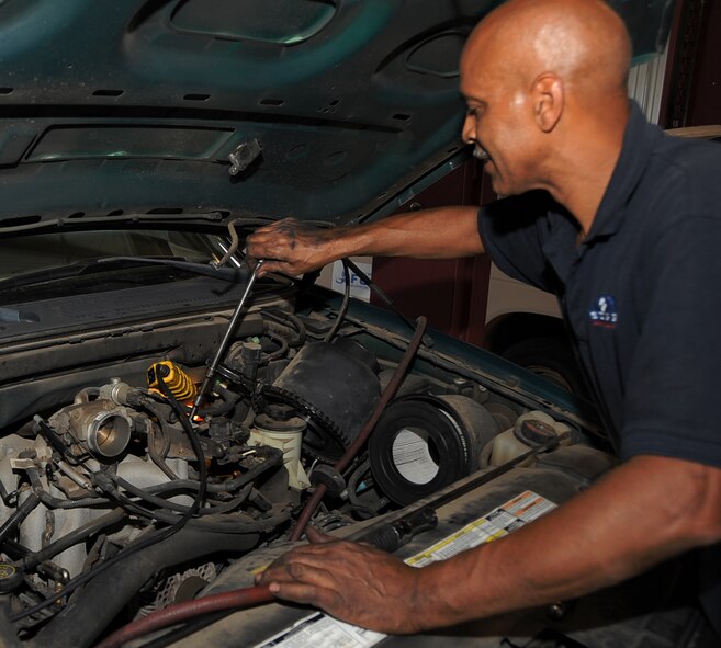 Tim Jackson, Auto Hobby Shop manager, changes the spark-plugs on a customer?s vehicle on Barksdale Air Force Base, La., June 3, 2013.  The Auto Hobby Shop location has 10 maintenance stalls, specialized tools, lifts and more for the do-it-yourself enthusiast?s to work on their cars, motorcycles, ATV?s and more.  (U.S. Air Force photo/Staff Sgt. Jason McCasland)