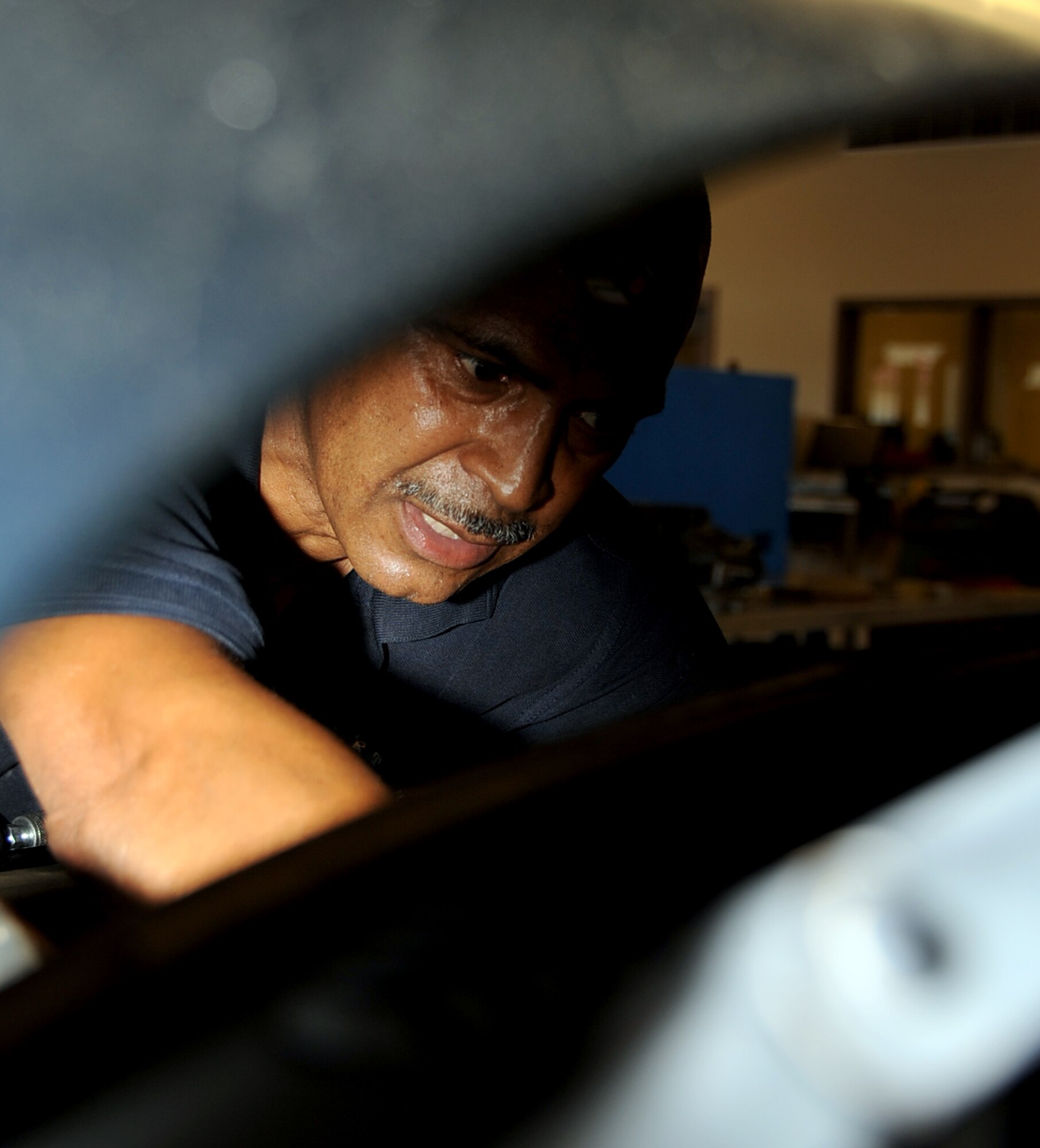 Tim Jackson, Auto Hobby Shop manager, changes the spark-plugs on a customer's vehicle on Barksdale Air Force Base, La., June 3, 2013.  The Auto Hobby Shop has certified mechanics on-duty that can offer free advice for the do-it-yourselfer or complete auto repairs for tune-ups, oil and brake changes and more.  (U.S. Air Force photo/Staff Sgt. Jason McCasland)