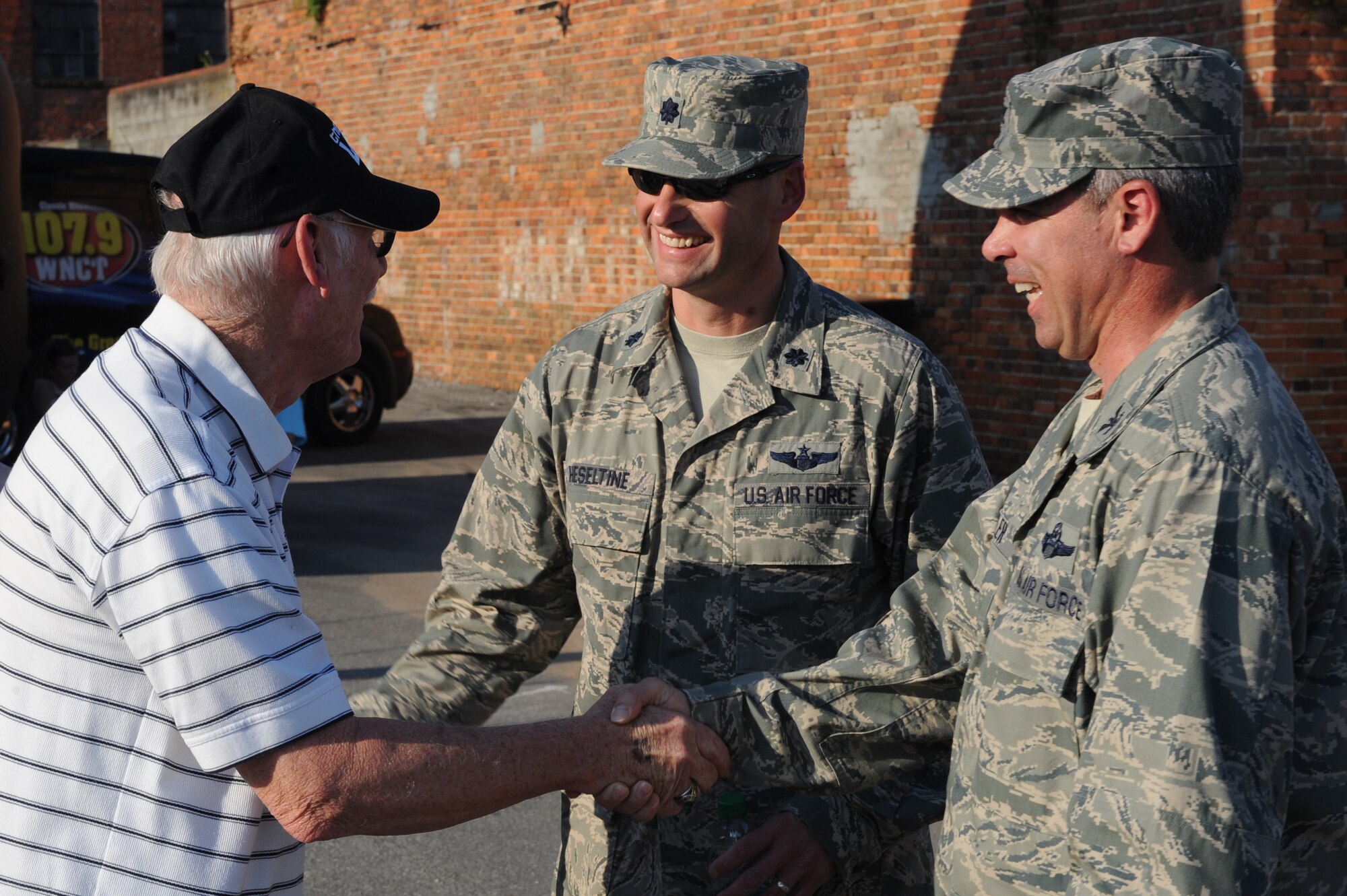 U.S. Air Force Col. Kevin Fesler, 4th Fighter Wing vice commander, and Lt. Col. Bruce Heseltine, 916th Operations Group deputy commander, shake hands with a local community member during the Center Street Jam at the Waynesborough House in Goldsboro, N.C., May 30, 2013.  The two leaders thanked patrons for their dedication and support toward Seymour Johnson Air Force Base.  (U.S. Air Force photo by Airman 1st Class Brittain Crolley/Released)