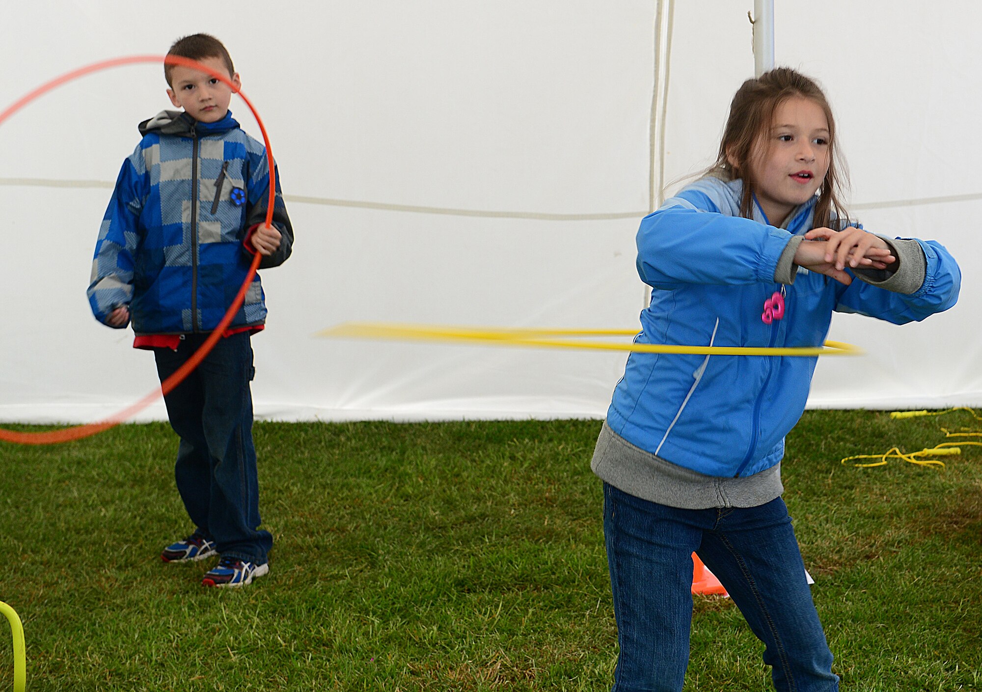 IPSWICH, England -- Alicia and Timothy Odom, children of Tech. Sgt. Timmy Odom, 48th Aerospace Medicine Squadron health and wellness center NCO in charge, hula hoop at the Suffolk Show May 30, 2013. The 48th AMDS Public Health office and HAWC worked with Healthy Ambitions to promote making Suffolk the healthiest county in England by 2028. (U.S. Air Force photo by Staff Sgt. Stephanie Mancha)
