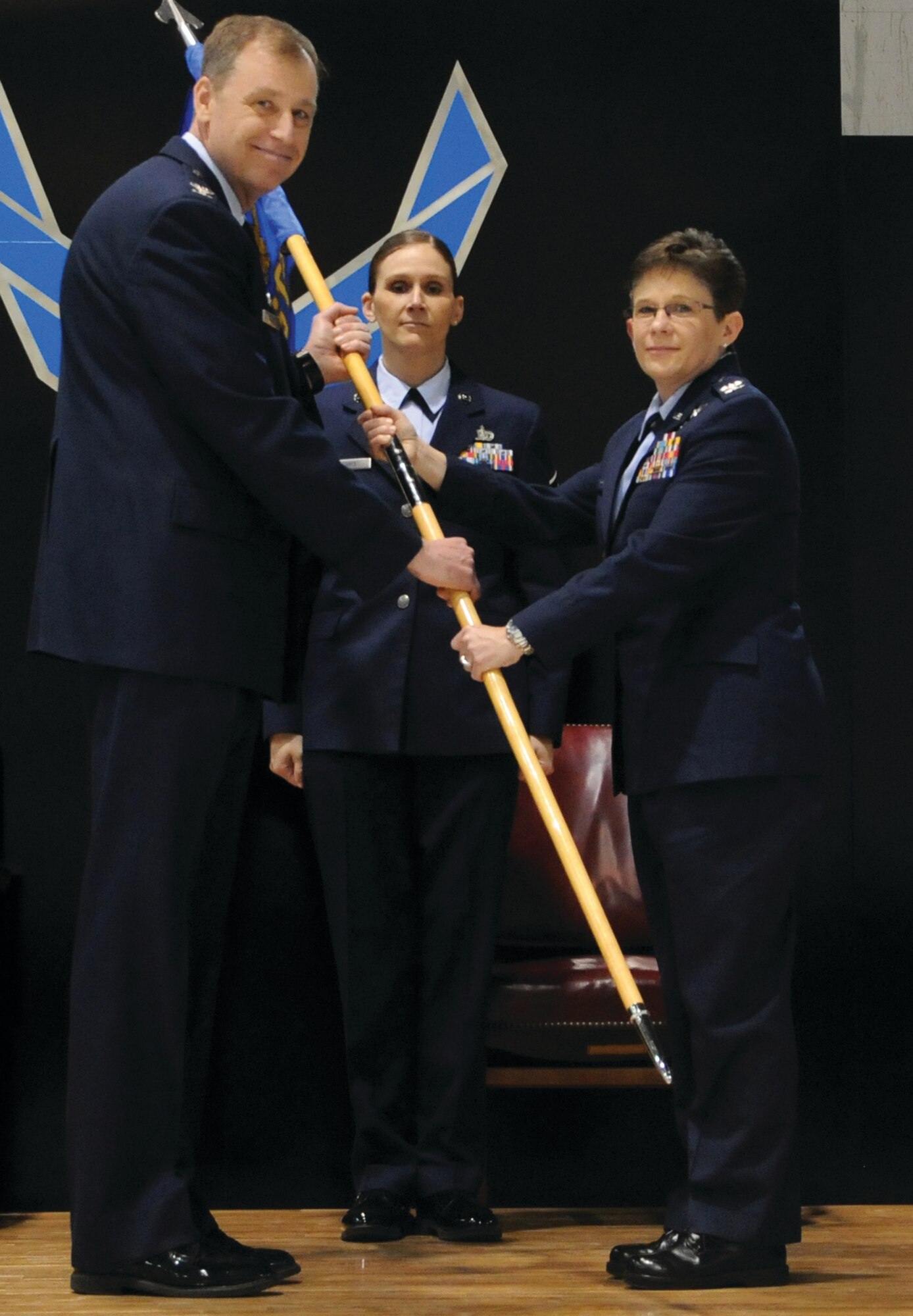 WRIGHT-PATTERSON AIR FORCE BASE, Ohio - Master Sgt. Leslie Nance, 445th Aeromedical Staging Squadron first sergeant, looks on as Col. Stephen Goeman, 445th Airlift Wing commander, passes the guidon to Col. Sheri Gladish, incoming 445 ASTS commander, during an Appointment of Command ceremony May 4. (U.S. Air Force photo/Tech. Sgt. Anthony Springer)