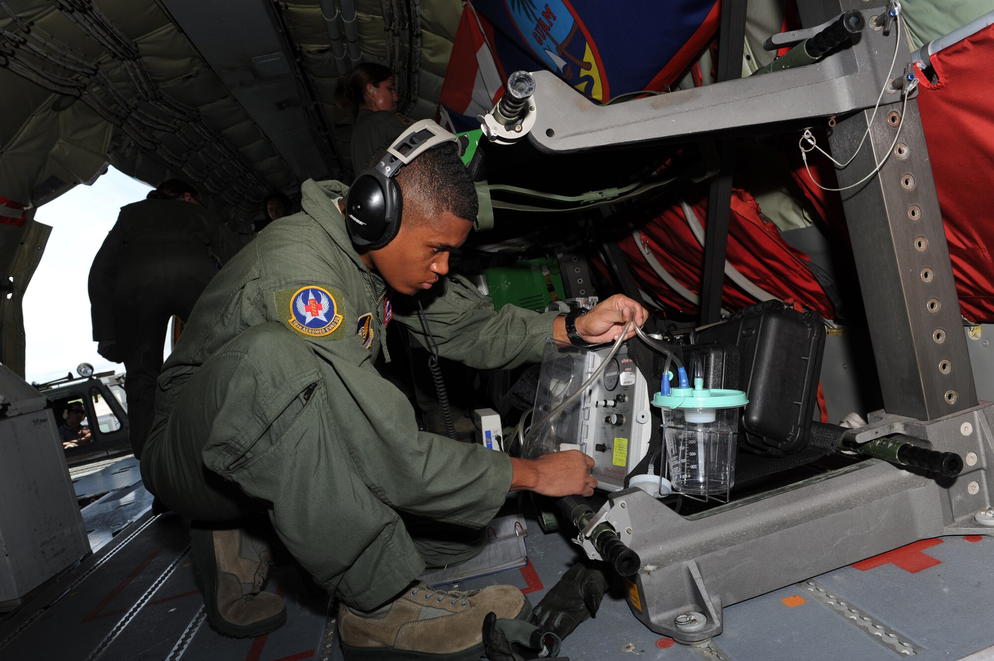 U.S. Air Force Senior Airman Yannick Sharras, 18th Aeromedical Evacuation Squadron aeromedical technician, performs a function check on the Impact 326M portable suction unit in a KC-135 Stratotanker on Kadena Air Base, Japan, May 29, 2013. Members of the 18th AES were preparing for an in-flight training exercise to involve various scenarios and improve upon life saving skills when treating and stabilizing patients while being transported. (U.S. Air Force photo by Airman 1st Class Keith A. James/Released)