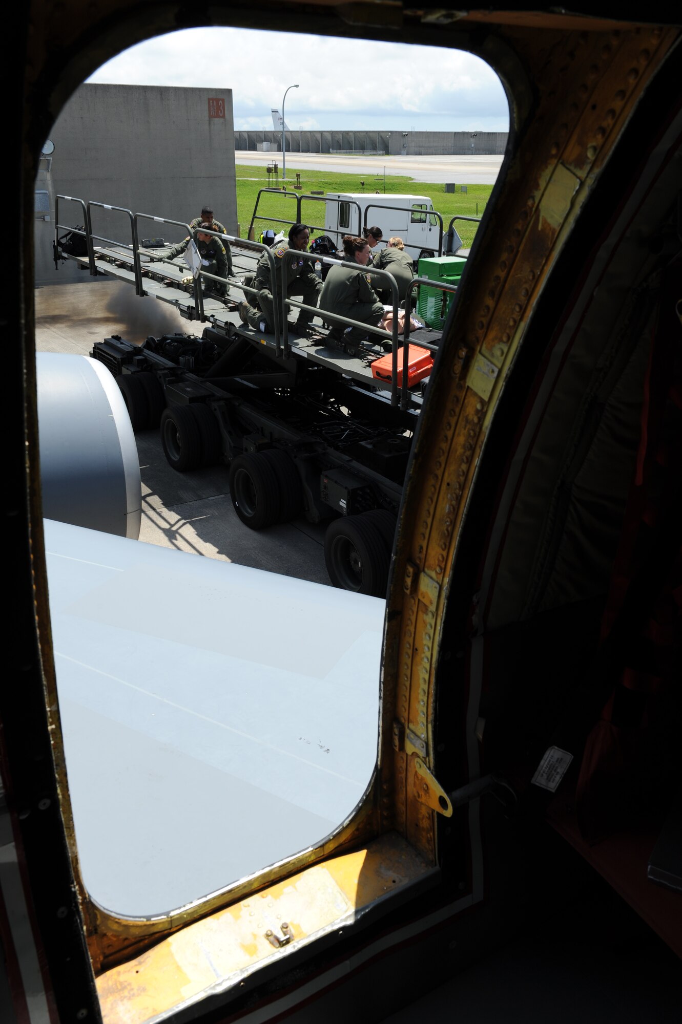 Members of the 18th Aeromedical Evacuation Squadron load and ride up on a K-loader on Kadena Air Base, Japan, May 29, 2013. The members were preparing for a training exercise, to improve their treating and stabilizing skills while patients are being transported. (U.S. Air Force photo by Airman 1st Class Keith A. James/Released)