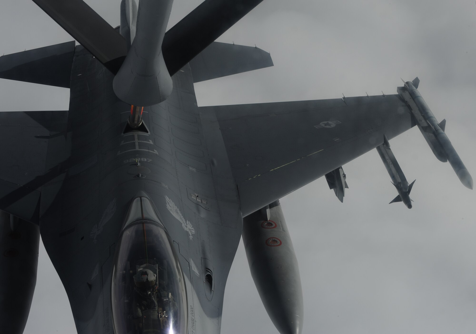 A KC-135 Stratotanker stationed at Kadena Air Base, Japan refuels a F-16 Fighting Falcon stationed at Misawa Air Base, Japan during training over the Pacific, May 29, 2013.The 18th Wing conducts refueling training regularly to ensure mission readiness for the common defense of Japan and the Asia-Pacific region. (U.S. Air Force photo by Airman 1st Class Keith A. James/Released)