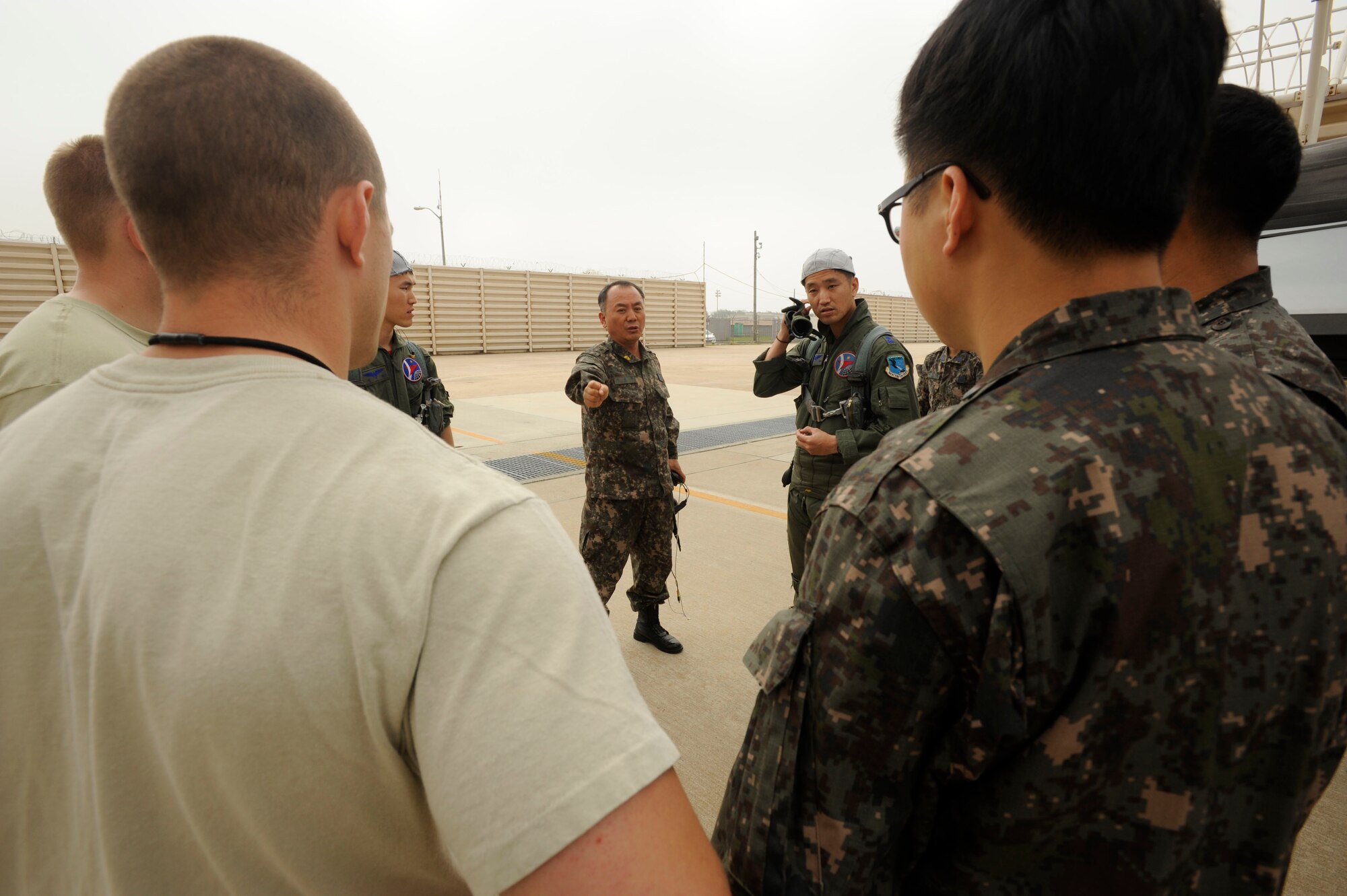 KUNSAN AIR BASE, Republic of Korea – Republic of Korea air Force Warrant Officer 1, Youn Joo Lee, 20th Fighter Wing crew chief, Seosan Air Base, ROK, divvies out responsibilities to ROKAF and U.S. Airmen, during a Buddy Wing Exchange at Kunsan Air Base Republic of Korea, May 23, 2013. Buddy Wing Exchanges not only allowed host nation pilots to fly together and exchange tactics, but also gave ROK and U.S. crew chiefs a chance to work alongside each other. (U.S. Air Force photo by Staff Sgt. Tong Duong/ Released) 