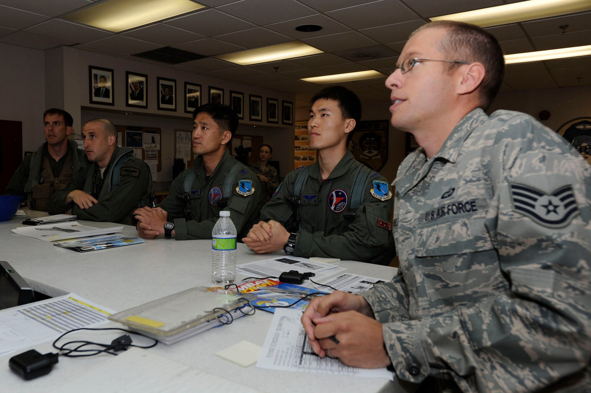 KUNSAN AIR BASE, Republic of Korea – Staff Sgt. Jason Belt, 8th Operations Support Squadron weather forecaster, right, gives a pre-flight brief to 80th Fighter Squadron pilots, left, and Republic of Korea pilots, middle, from 20th Fighter Wing, 120th FS, Seosan Air Base, during a Buddy Wing Exchange at Kunsan AB, ROK, May 23, 2013. (U.S. Air Force photo by Staff Sgt. Tong Duong/ Released) 