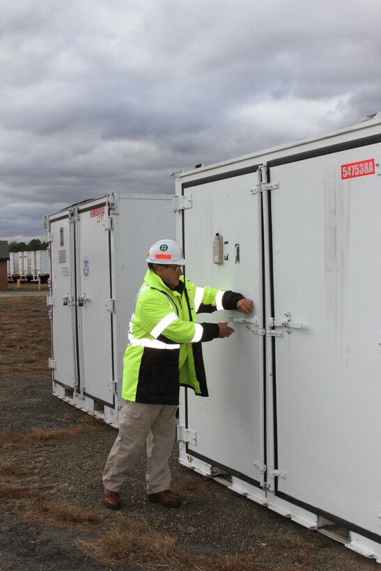 Bob Nebbio, a logistics specialist for an Emergency Power response team, checks a generator scheduled for installation after Hurricane Sandy. USACE had more than 3,000 employees within the North Atlantic Division with an additional 990 team members deployed from other USACE divisions across the Nation, engaged to support the Hurricane Sandy response mission