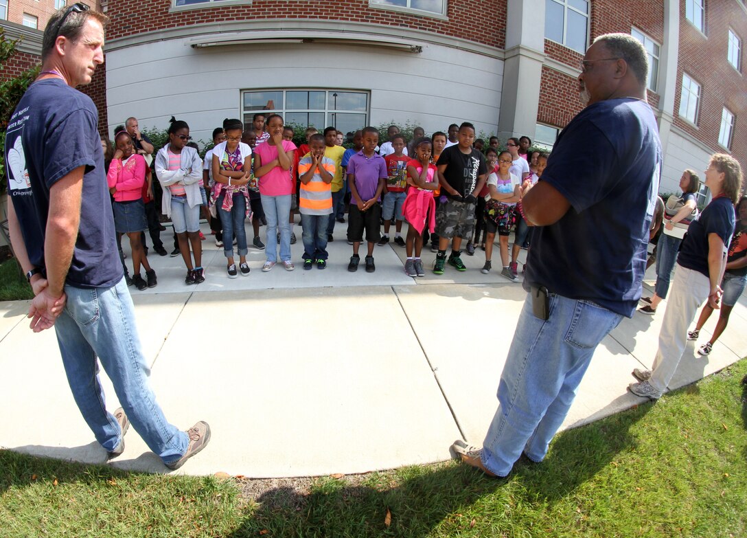 NORFOLK -- Students from Seatack Elementary School in Virginia Beach, Va., get a safety brief from Oscar Harts (center) after arriving at the Norfolk District before being escorted to the oyster gardening site by Jeff Swallow (left) and Karin Dridge.