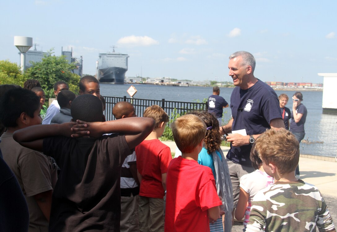 NORFOLK -- Col. Paul Olsen, Norfolk District commander, greets the Seatack Elementary students and quizes them on oysters.