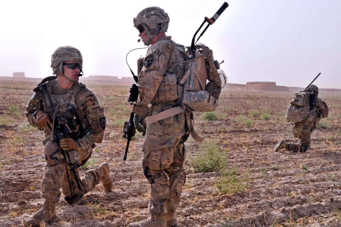 U.S. Army 1st. Lt. James Whitler, left kneeling, speaks with one of his soldiers during a dismounted presence patrol near Forward Operating Base Spin Boldak in Kandahar province, Afghanistan, June 2, 2013. Whitler is assigned to Company B, 2nd Battalion, 23rd Infantry Regiment.