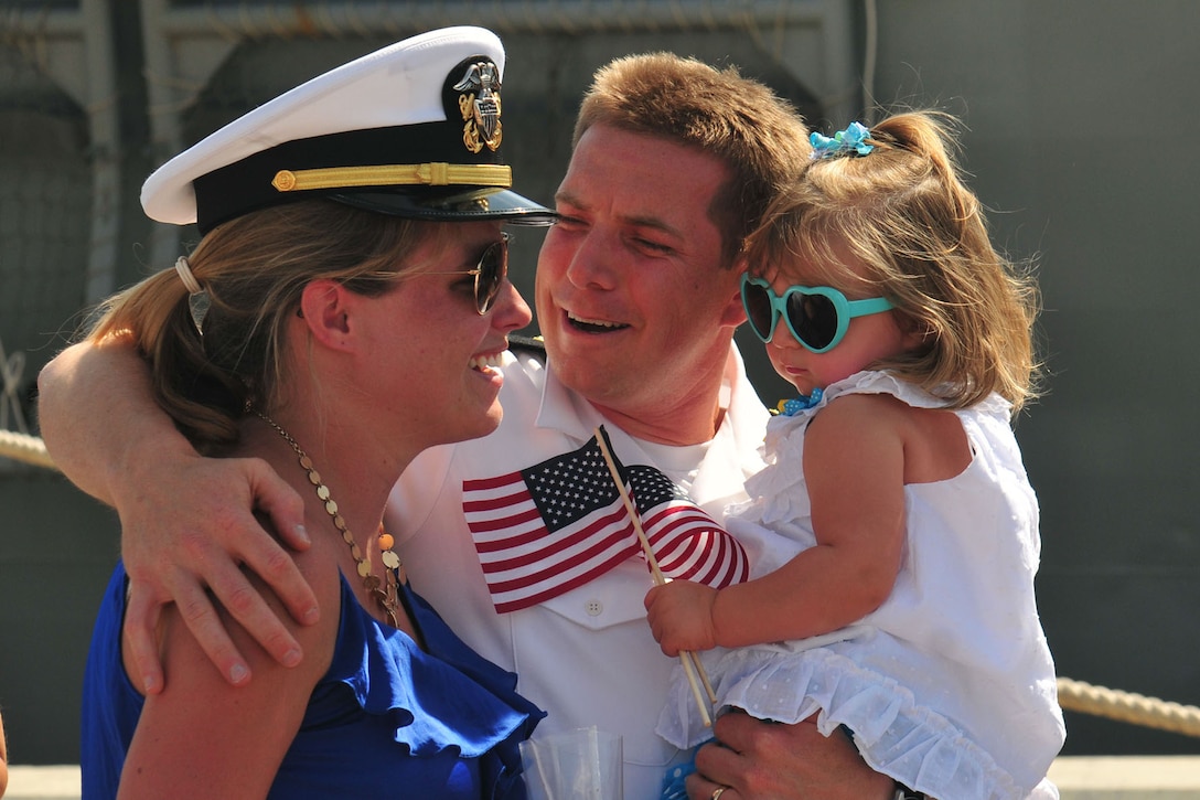 Navy Lt. Andrew Wood is greeted by his wife daughter during a homecoming celebration as the guided-missile frigate USS Robert G. Bradley returns from a seven-month deployment in Mayport, Fla., May 28, 2013. The Bradley and embarked Helicopter Sea Combat Squadron 22, Detachment 5, were deployed to the U.S. 6th Fleet area of responsibility in support of United States Africa Command counter-terrorism, intelligence and reconnaissance missions. 