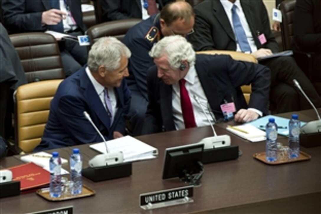 U.S. Defense Secretary Chuck Hagel, left, speaks with Pierre Vimont, secretary general of the European External Action Service, during a meeting with non-NATO International Security Assistance Force contributing nations at NATO headquarters in Brussels, June 5, 2013. 