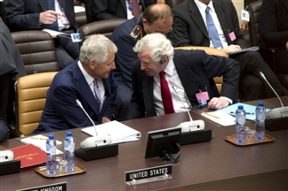 Secretary of Defense Chuck Hagel, left, speaks with Secretary General of the European External Action Service Pierre Vimont during a meeting with non-NATO ISAF contributing nations at NATO headquarters in Brussels, Belgium, on June 5, 2013.  