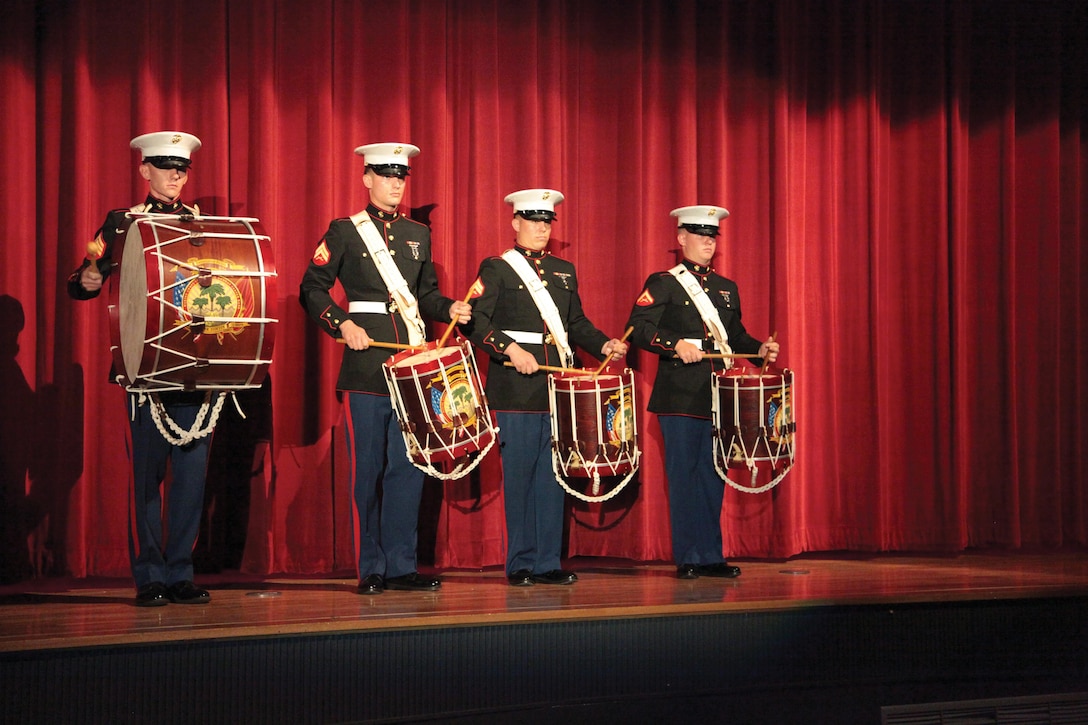 The III Marine Expeditionary Force Band’s drum line performs June 1 at the Camp Foster Theater during the band’s Friendship Summer Concert. “We represent a small piece of the U.S., so I think the community really looks forward to coming to our concerts,” said Gunnery Sgt. William D. Mike III, the drum major with the band. “It gives them a taste of what some of us call home.” Photo by Lance Cpl. Pete Sanders