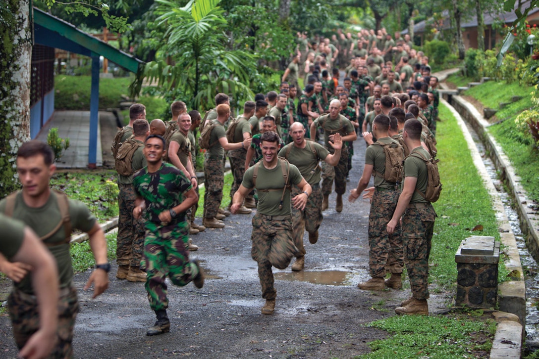 Indonesia and U.S. Marines run during a morning physical training session May 23 during Cooperation Afloat Readiness and Training 2013 in Antralina, Indonesia. The Indonesia Marines are with Company A, 6th Infantry Battalion, 2nd Infantry Brigade, Korps Marinir, and the U.S. Marines are with Company I, 3rd Battalion, 3rd Marine Regiment, 3rd Marine Division, III Marine Expeditionary Force. Photo by Cpl. John C. Lamb