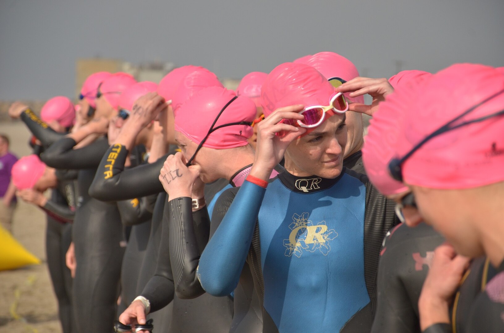 Women Service members from across the Armed Forces line up ready to jump in the Pacific Ocean off the coast of NBVC Point Mugu, CA for the start of the 2013 Armed Forces Triathlon Championship.