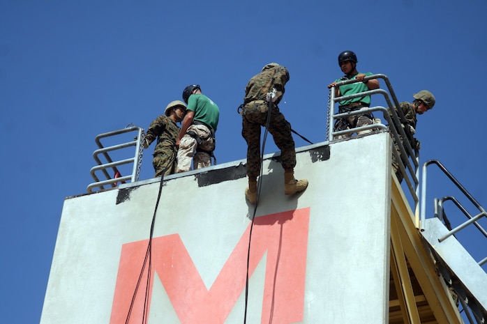 A recruit of Company G, 2nd Recruit Training Battalion, begins his descent of the rappel tower aboard MArine Corps Recruit Depot San Diego, May 31.