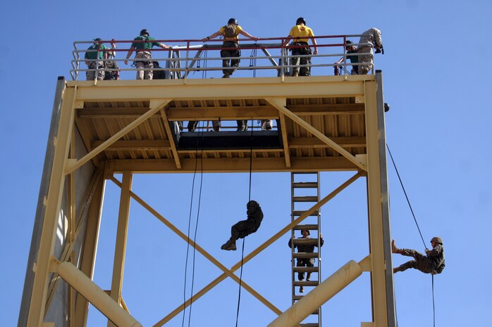 Recruits of Company G, 2nd Recruit Training Battalion, rappel the 70-foot tower aboard Marine Corps Recruit Depot San Diego, May 31. The rappel tower is one of the mlast obstacles recruits face during training.