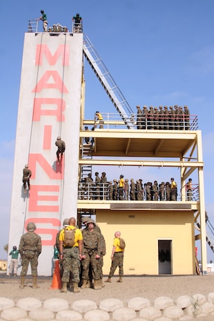 Recruits of Company G, 2nd Recruit Training Battalion, descend the rappel tower aboard Marine Corps Recruit Depot San Diego, May 31. The rappel tower stands 70 feet high and is designed for recruits to overcome any fear of heights.