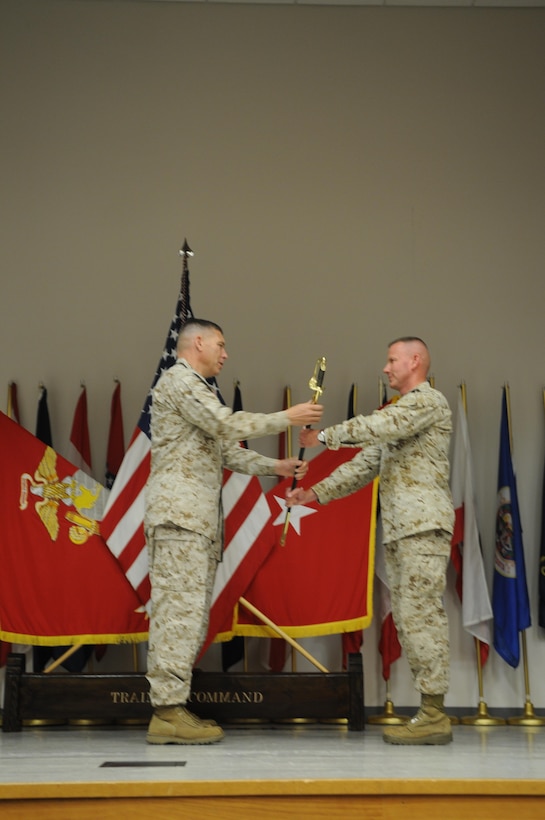 In a post-and-relief ceremony at Geiger Hall on June 4, Brig. Gen. John W. Simmons, commanding general of Training Command, passes the ceremonial noncommissioned officer sword to Sgt. Maj. William Sowers, the command’s new sergeant major. Sowers is the former sergeant major of Combat Logistics Regiment 15, 1st Marine Logistics Group at Marine Corps Base Camp Pendleton, Calif. Sgt. Maj. Paul McKenna was relieved of his post as the command sergeant major at the ceremony and will head to Okinawa to join the 3rd Marine Division. Having patrolled with Sowers in Afghanistan, McKenna said he “knew immediately he has the leadership and the talent that is needed in a command like this.” 