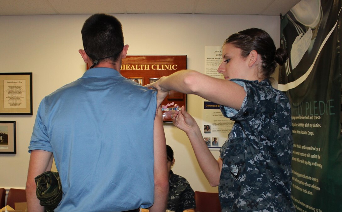 Seaman Apprentice Rachel Jones gives an immunization to an officer candidate from the Officer Candidate School’s incoming India Company on May 28, the first day of the OCS clinic’s Operation Bulldog, which sees the student body and the clinic’s staff triple for the summer. The clinic processed about 200 students that day and about 400 the next day. 