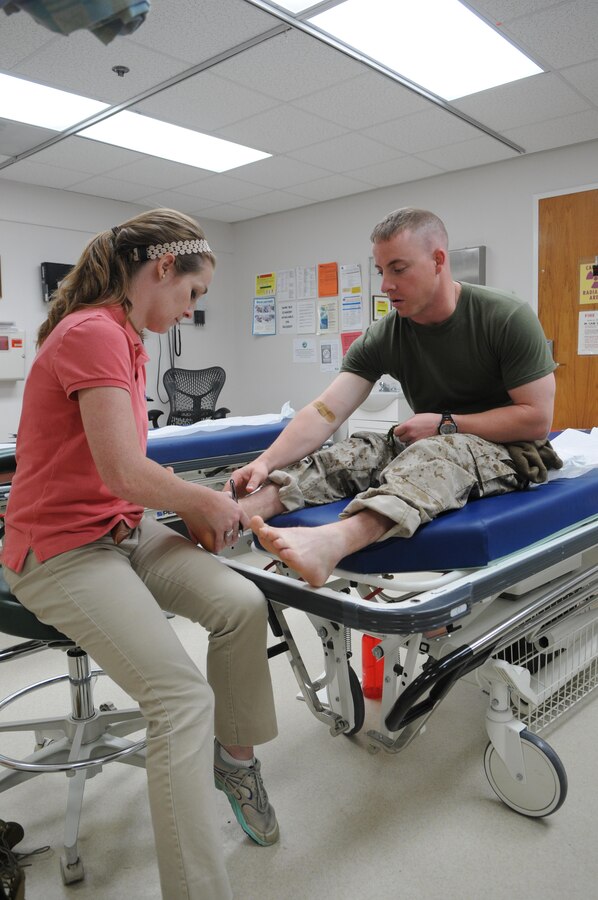 Athletic Trainer Alicia Heili checks 2nd Lt. Nicholas Norville’s ankle to make sure he’s fit to train during the mass in-processing of The Basic School’s Delta Co. at the David R. Ray Branch Clinic on May 29. 