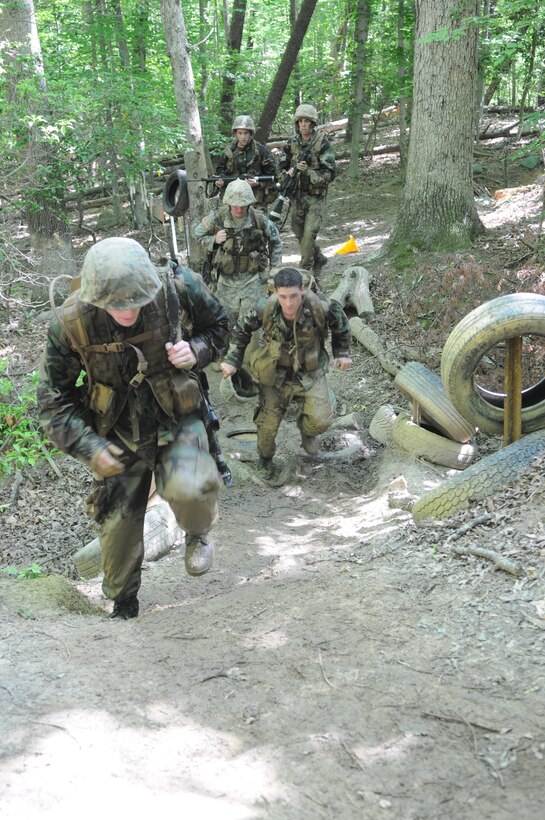 A group of midshipmen tromp through the mud on the endurance course May 31. About 345 aspiring Marine Corps officers from the Naval Academy are at Quantico to test their mettle during their Leatherneck training. 