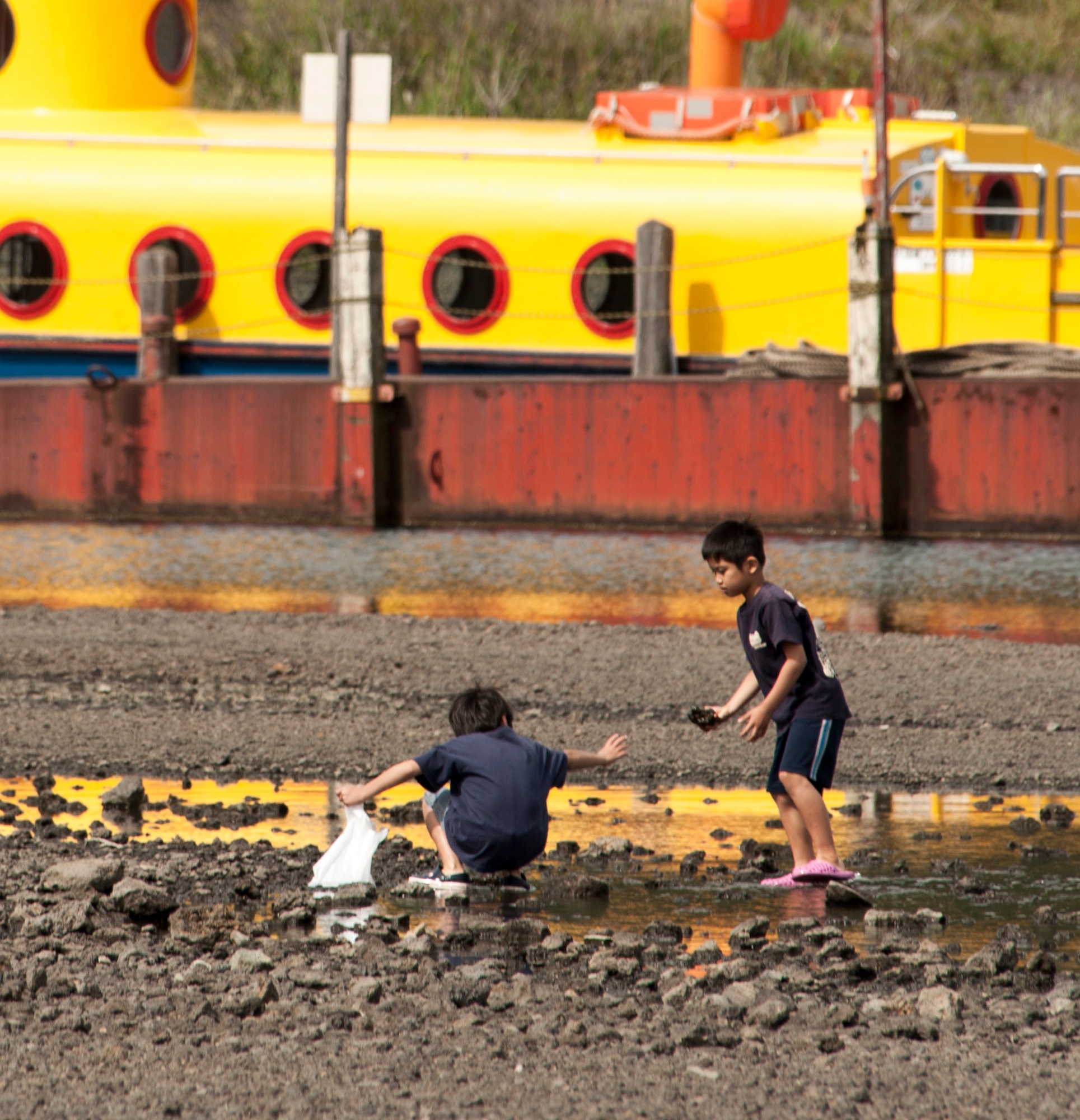 LAKE MOTOSU, Japan -- Children remove trash from the rocky shore of Lake Motosu, Japan, June 1, 2013. They were helping out with Motosuko Cleanup, a volunteer effort to remove trash and debris from the lake bottom. (U.S. Air Force photo by Senior Airman Michael Washburn)