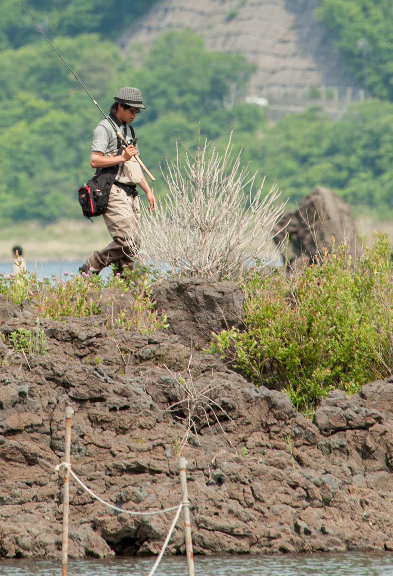 LAKE MOTOSU, Japan -- A man walks back to dry land after fishing in Lake Motosu, Japan, June 1, 2013. Lake Motosu is the ninth deepest lake in Japan at 140 meters. (U.S. Air Force photo by Senior Airman Michael Washburn)