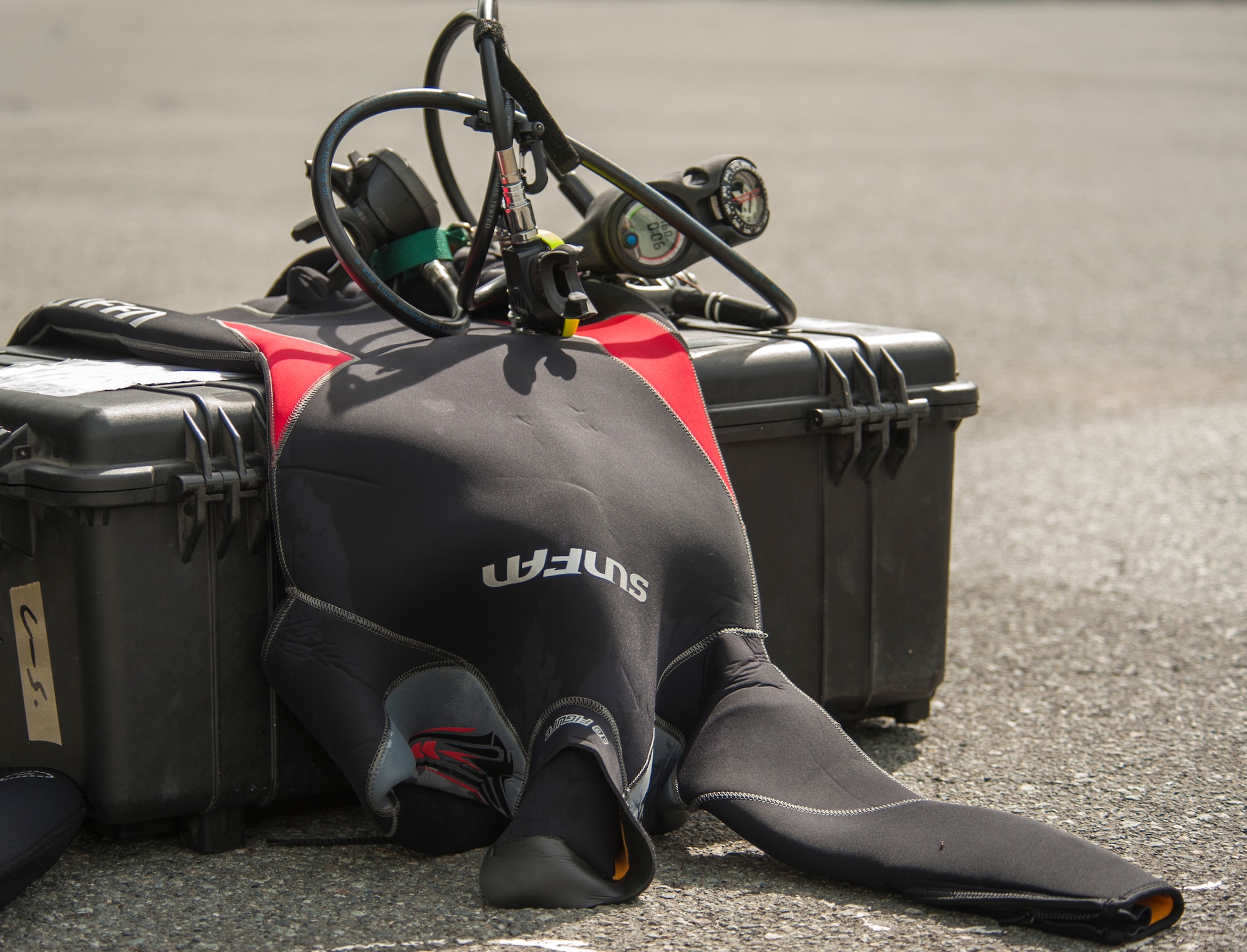LAKE MOTOSU, Japan -- Scuba diving equipment lies on an equipment case at Lake Motosu, Japan, June 1, 2013. More than 100 volunteers and divers participated in the project to remove debris from the lake bottom. (U.S. Air Force photo by Senior Airman Michael Washburn)
