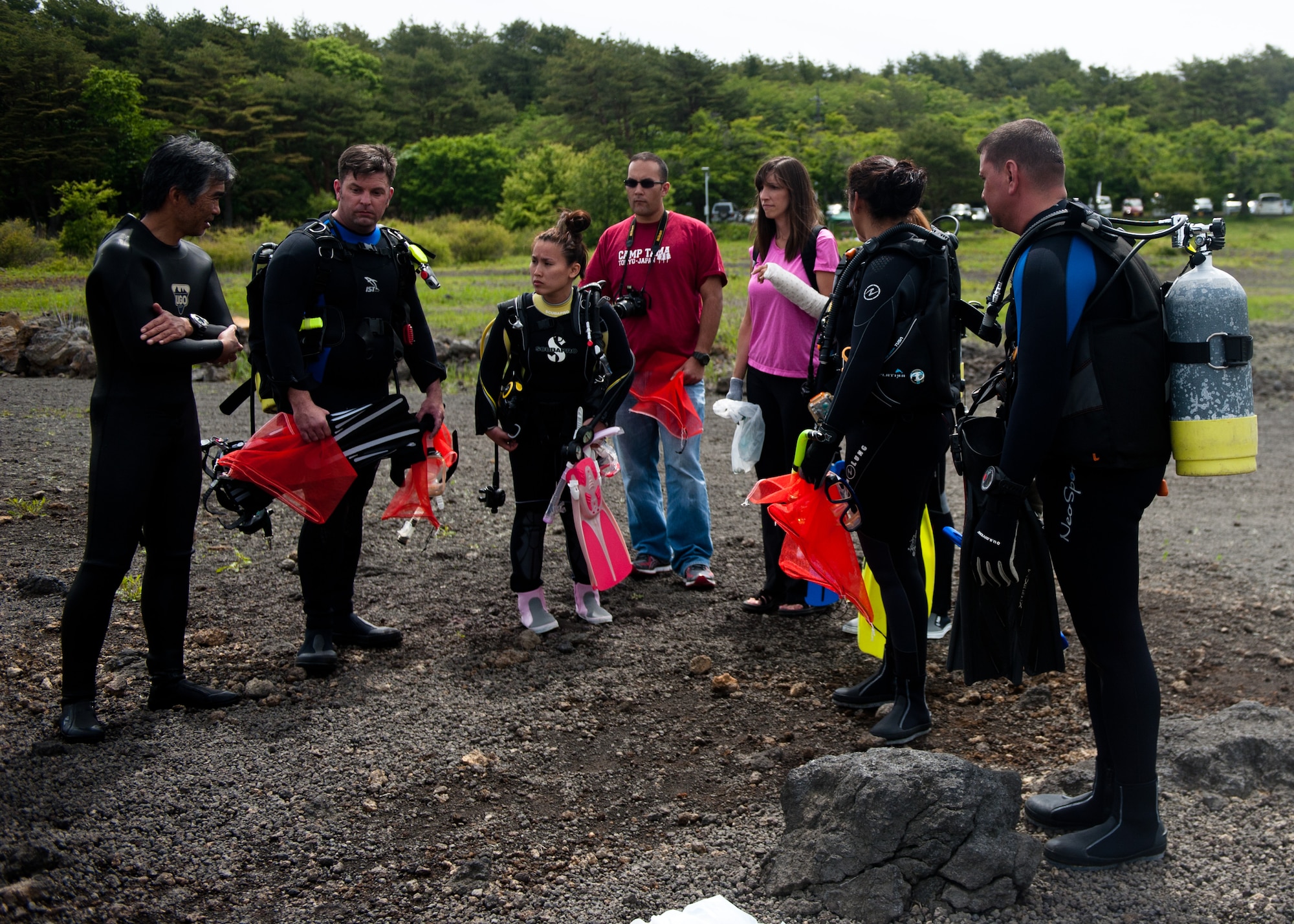 LAKE MOTOSU, Japan -- Yokota Air Base Dive Club members discuss their goal before scuba diving at Lake Motosu, Japan, June 1, 2013. The dive members ventured to the lake to assist a local, volunteer project—Motosuko Cleanup-- to remove debris from the lake bottom. (U.S. Air Force photo by Senior Airman Cody H. Ramirez) 