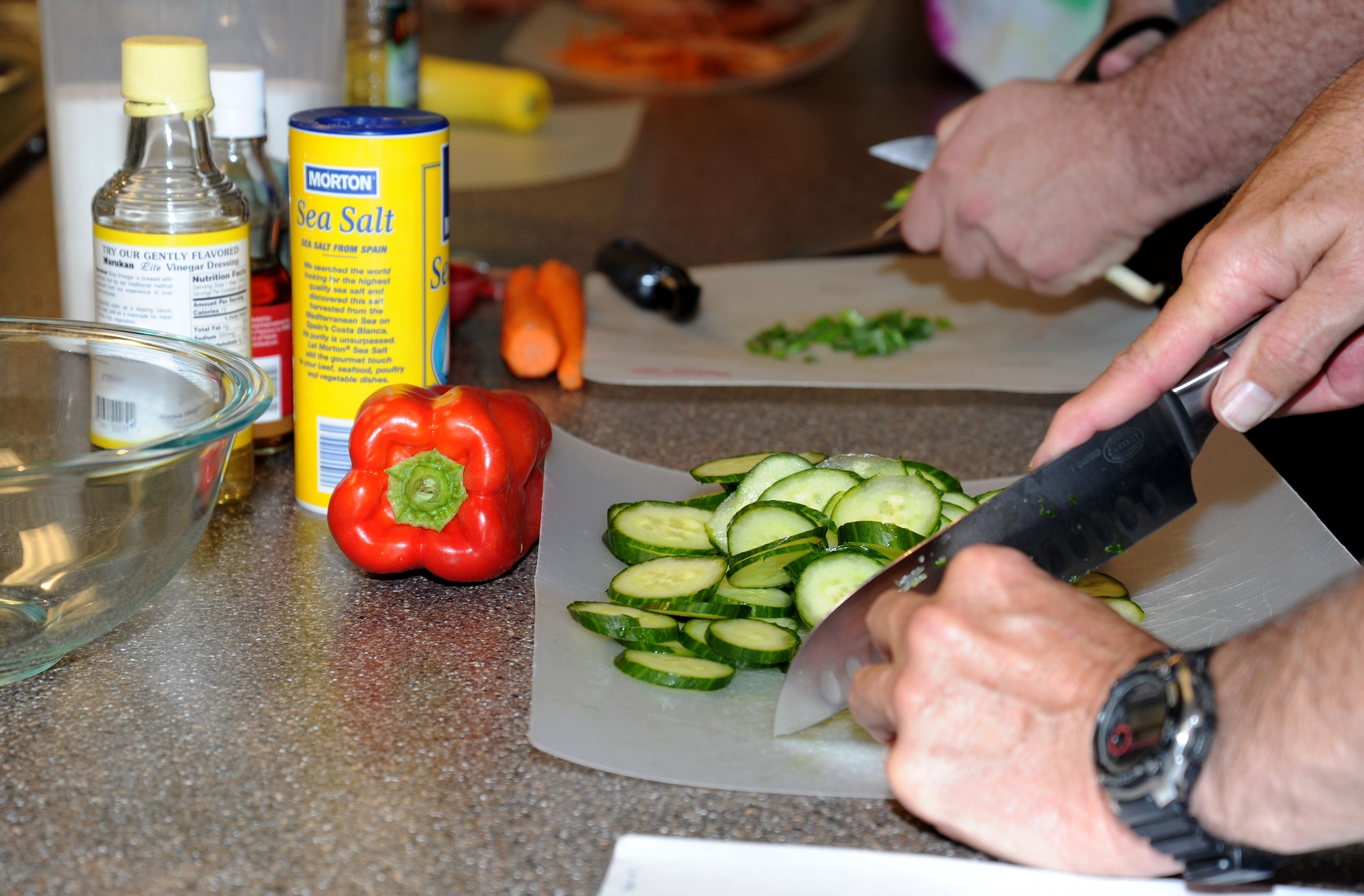 Lt. Col. (ret.) Jim “Stormy” Weathers, a former B-52 navigator cuts a cucumber during the healthy cooking class.(U.S. Air Force photo by 2nd. Lt. Rachelle Smith/Released)