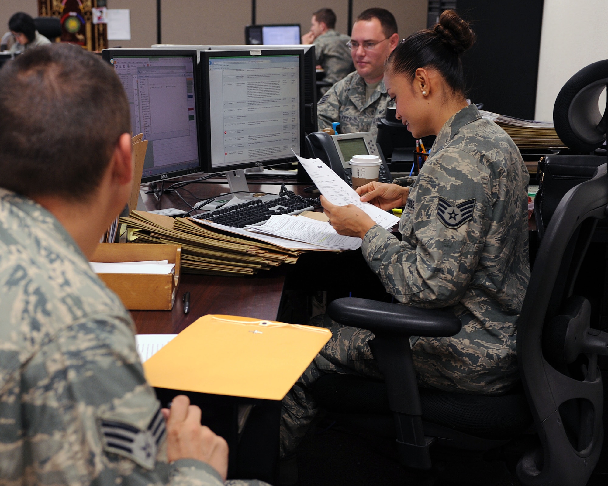U.S. Air Force Staff Sgt. Romalyn Vanderloop, 355th Force Support Squadron helps an Airman in the process of permanent change of station at Davis-Monthan Air Force Base, Ariz., June 5, 2013. D-M’s Outbound Assignments office deals with 650 to 900 assignments during the busiest permanent change of station periods (U.S. Air Force photo by Airman 1st Class Christine Griffiths/Released)