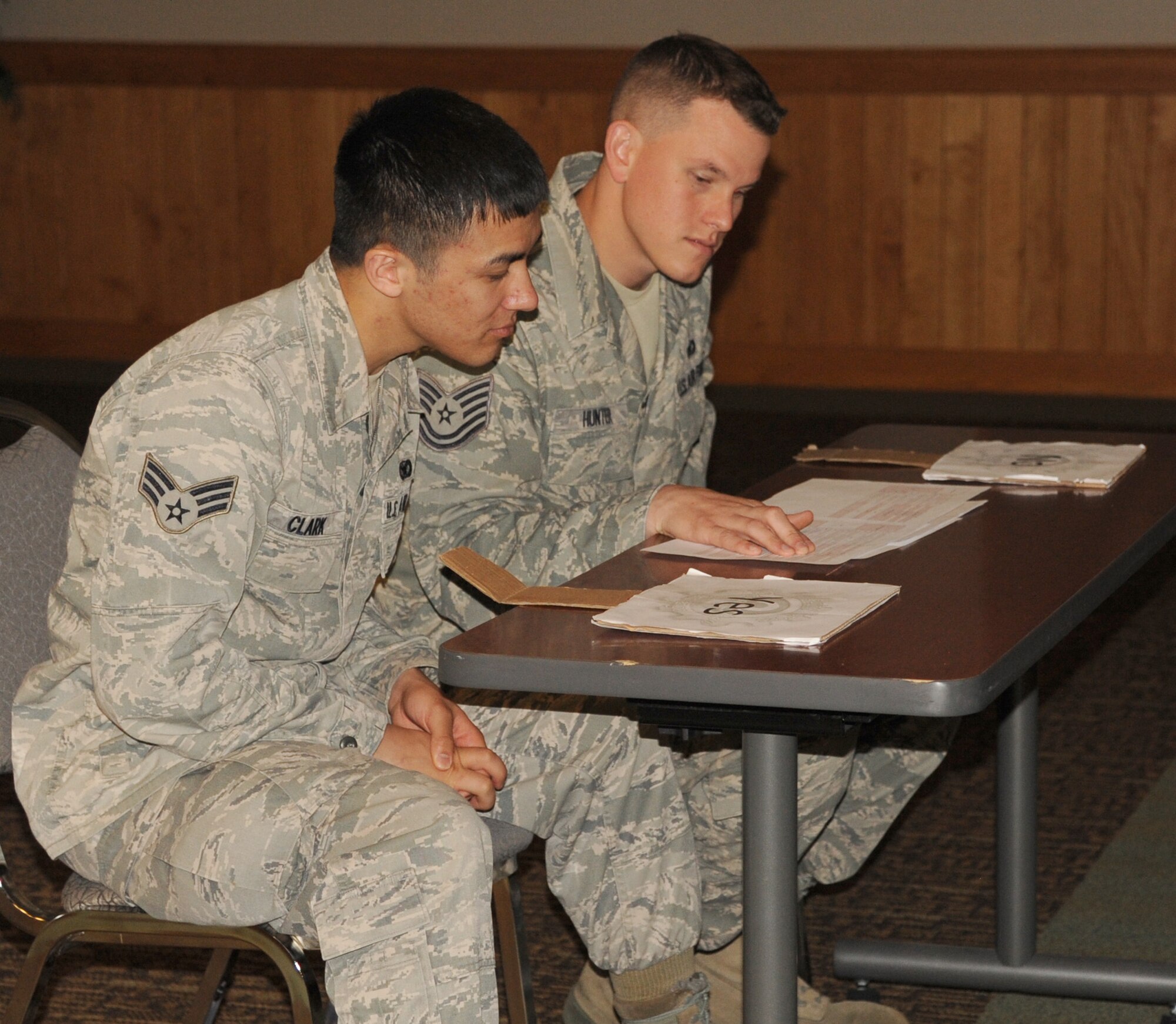 Senior Airman Jonathan Clark and Tech. Sgt. Joseph Hunter, both 341st Missile Security Forces Squadron members, judge a contestant’s answer during the second annual 341st Security Forces Group Game Show Challenge at the Grizzly Bend on May 31. The challenge, which consisted of security forces-specific job knowledge questions, brought in more than 150 attendees. (U.S. Air Force photo/Airman 1st Class Katrina Heikkinen)