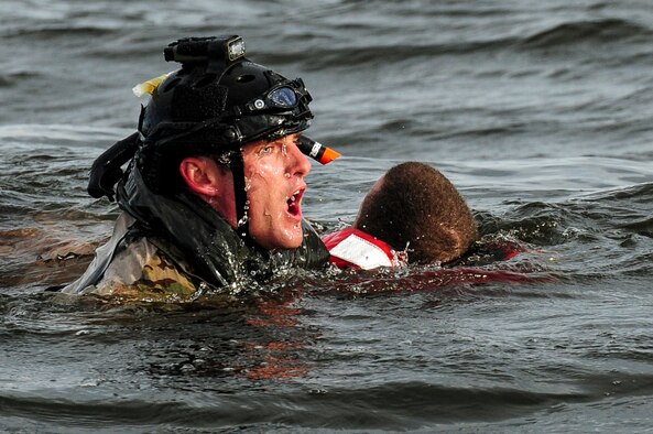 A U.S. Air Force airman from the 23rd Special Tactics Squadron swims to a boat after rescuing a simulated crash victim at Whynnehaven Beach, Fla., April 9, 2013. The 23rd STS trains, equips and employs combat control, pararescue and support personnel in response to presidential and secretary of defense tasks. (U.S. Air Force photo/Airman 1st Class Christopher Callaway)
