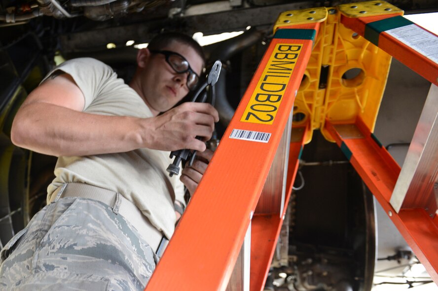 Airman 1st Class Brandon Smith, 2nd Maintenance Squadron, prepares safety wire for installation in the Phase Hangar on Barksdale Air Force Base, La., June 5, 2013. Safety wire is used to secure small parts to the aircraft to prevent objects like nuts and bolts from causing damage if they come loose. (U.S. Air Force photo/Senior Airman Micaiah Anthony)
