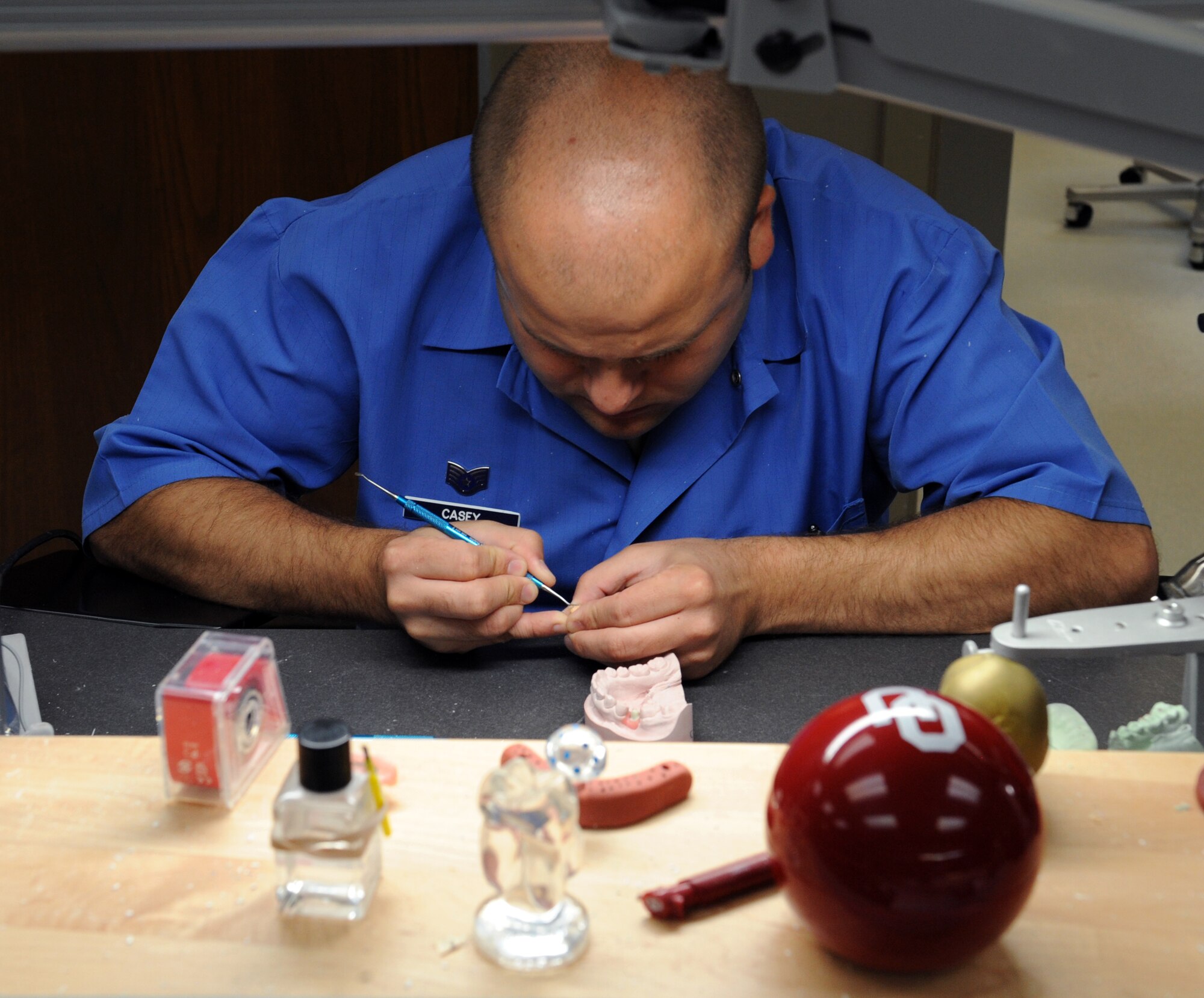 Staff Sgt. Christopher Casey, 2nd Dental Squadron dental lab technician, waxes a crown on Barksdale Air Force Base, La., June 6, 2013. The dental laboratory provides assistance to the 2nd DS by providing doctors with the services they need such as fabricating prostheses, creating molds of patient's teeth and providing accurate dental imagery. (U.S. Air Force photo/Airman 1st Class Benjamin Gonsier)