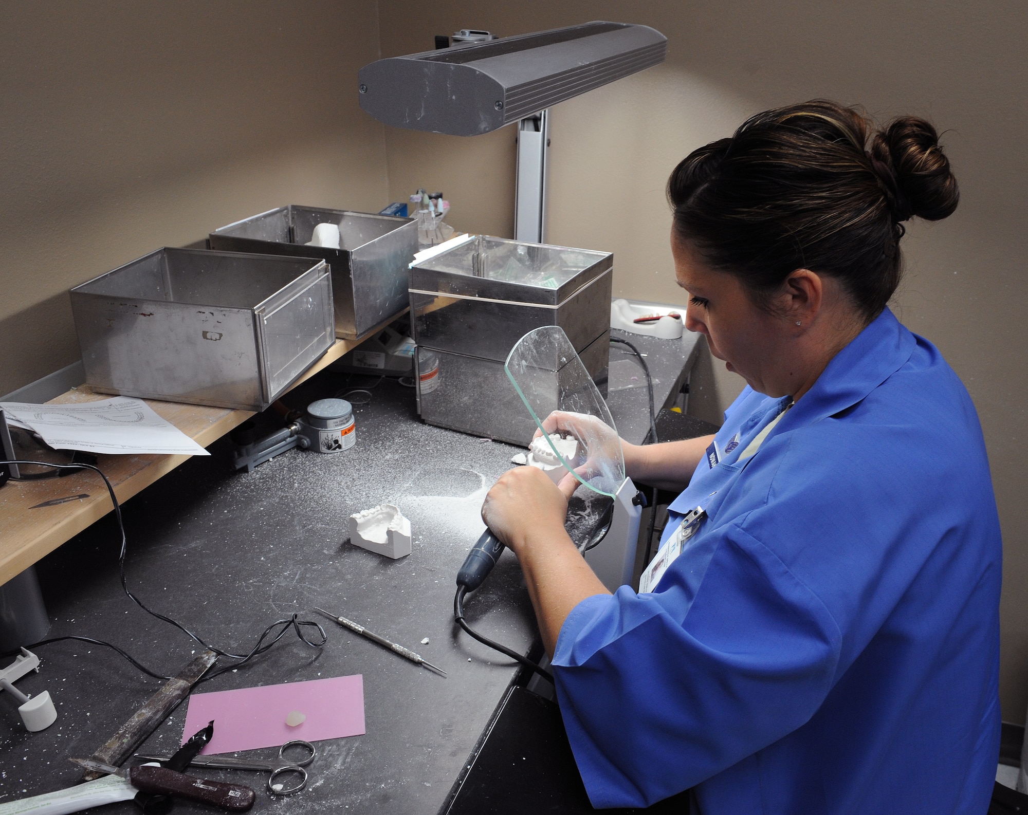 Staff Sgt. Heather Nowak, 2nd Dental Squadron dental lab technician, carves a mold of a patient's teeth on Barksdale Air Force Base, La., June 6, 2013. Before receiving braces, a patient will have a replica of their mouth made so the orthodontist can make a dental plan based on their needs. (U.S. Air Force photo/Airman 1st Class Benjamin Gonsier)
