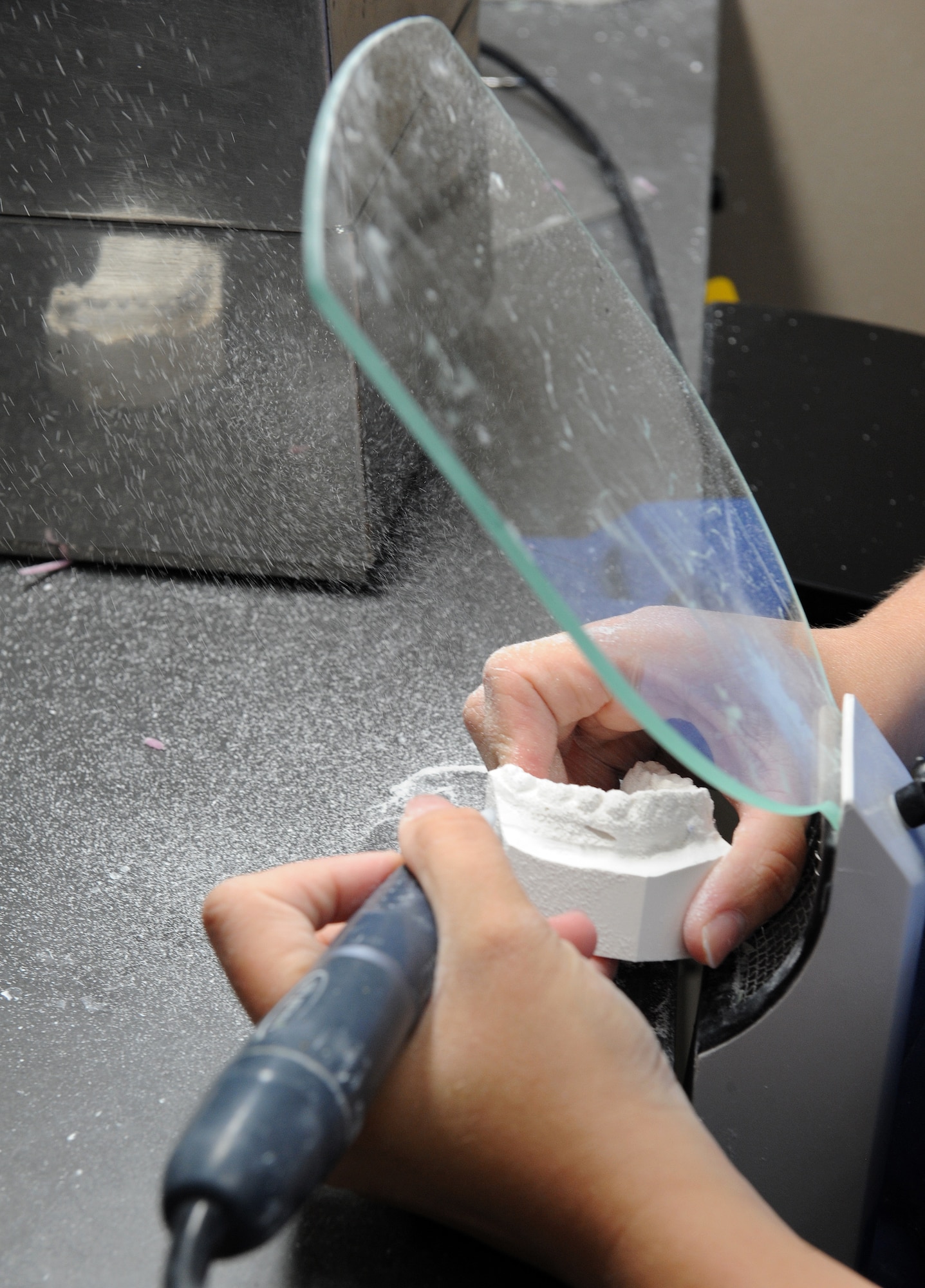 Staff Sgt. Heather Nowak, 2nd Dental Squadron dental lab technician, carves a dental mold of a patient's teeth on Barksdale Air Force Base, La., June 6, 2013. Before receiving braces, a patient will have a replica of their mouth made so the orthodontist can make a dental plan based on their needs. (U.S. Air Force photo/Airman 1st Class Benjamin Gonsier)
