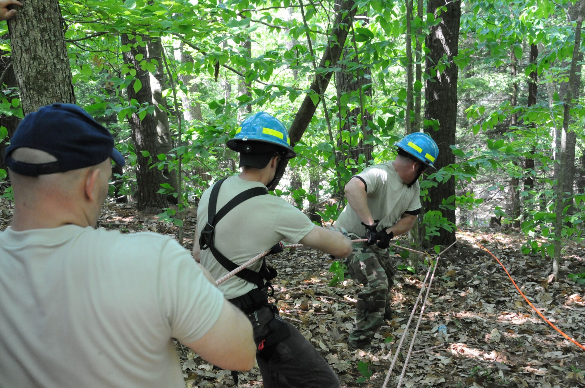 ROCHESTER, N.H. -- (left to right) Tech. Sgt. Darrell T. Jeffers, Senior Airman Nicholas McPhee and Tech. Sgt. Richard Wallingford pull up other members of their Urban Search and Rescue Team on a Stokes basket during high angle and low angle evacuation training, June 2, 2013. (U.S. Air National Guard photo by Staff Sgt. Curtis J. Lenz/RELEASED)