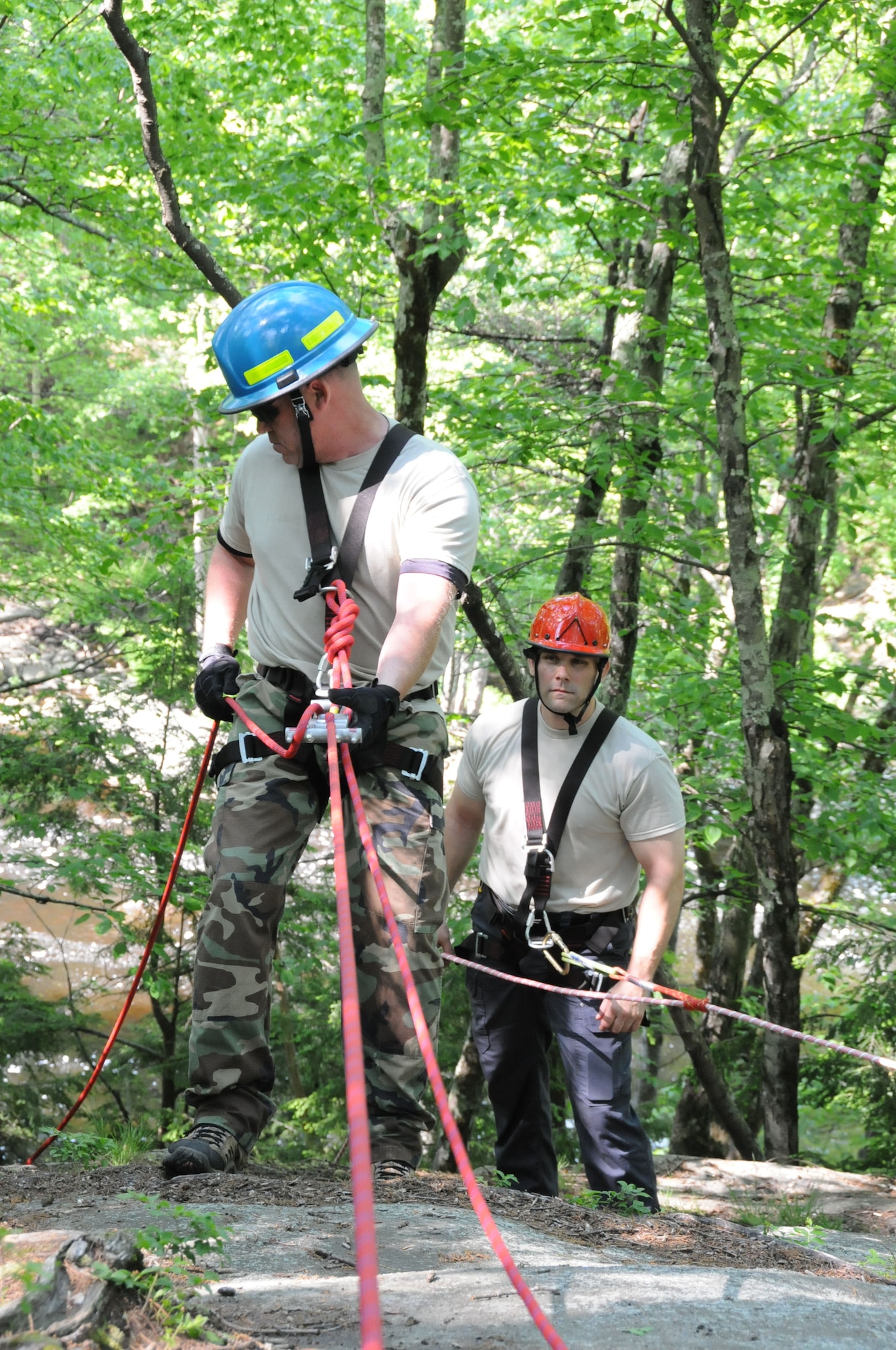 ROCHESTER, N.H. -- Tech. Sgt. Richard Wallingford rappels down a cliff here while training on high angle and low angle evacuation, June 2, 2013 as Tech. Sgt. Darrell T. Jeffers looks on. Wallingford is assigned to the 157th Civil Engineering Squadron, as a member of the Pease Urban Search and Rescue Team. (U.S. Air National Guard photo by Staff Sgt. Curtis J. Lenz/RELEASED)