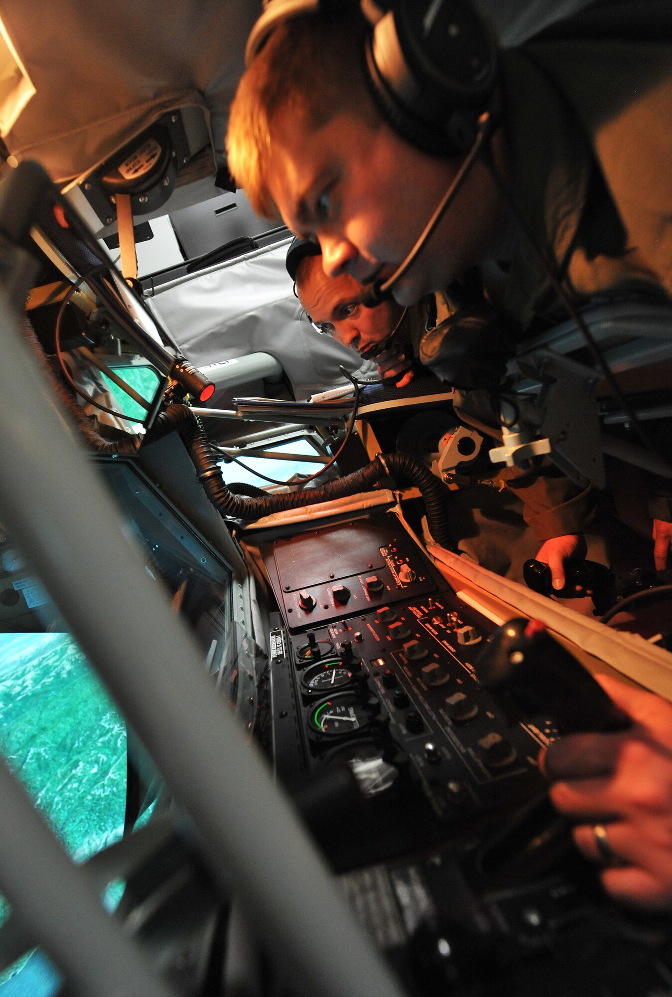 (Left to right) Senior Airman James Michel and Tech. Sgt. Jason Burianek, 384th Air Refueling Squadron boom operators, use a KC-135 Stratotanker Boom Operator Weapon System Trainer to simulate in-flight refueling, June 5, 2013 at McConnell Air Force Base, Kan. This technology is currently available at three Air Force bases, with additional systems scheduled to be installed throughout the Air Force this year. With an operating cost of roughly $700, the BOWST drastically cuts down costs compared to an eight hour tanker sortie at $49,000, while helping McConnell’s operators to focus on student qualification requirements, emergency procedures, and meet their global air refueling mission. (U.S. Air Force photo/ Staff Sgt. Jess Lockoski) 